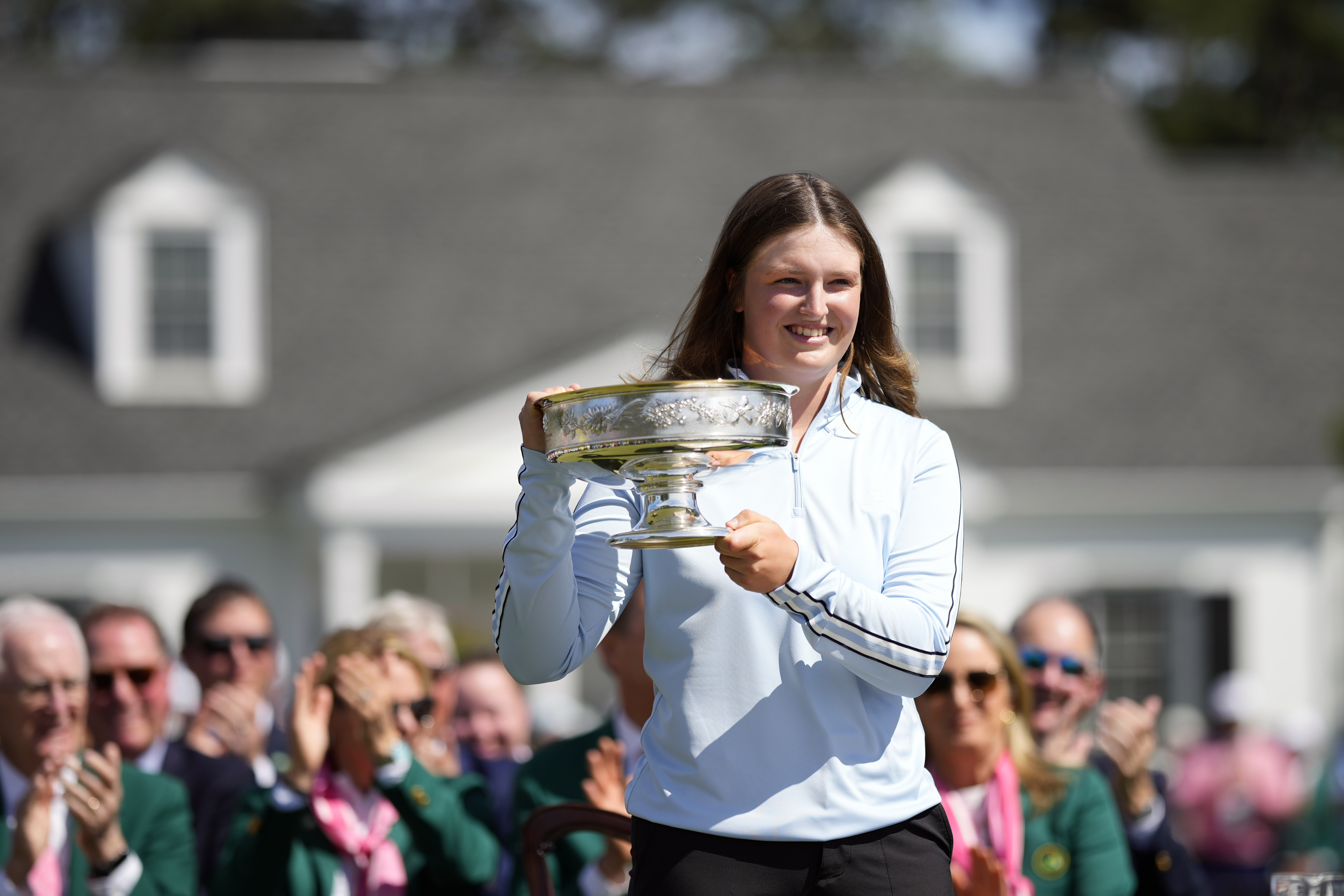 Lottie Woad, of England, poses with the trophy for photographers after winning the Augusta National Women's Amateur golf tournament, Saturday, April 6, 2024, in Augusta, Ga. 