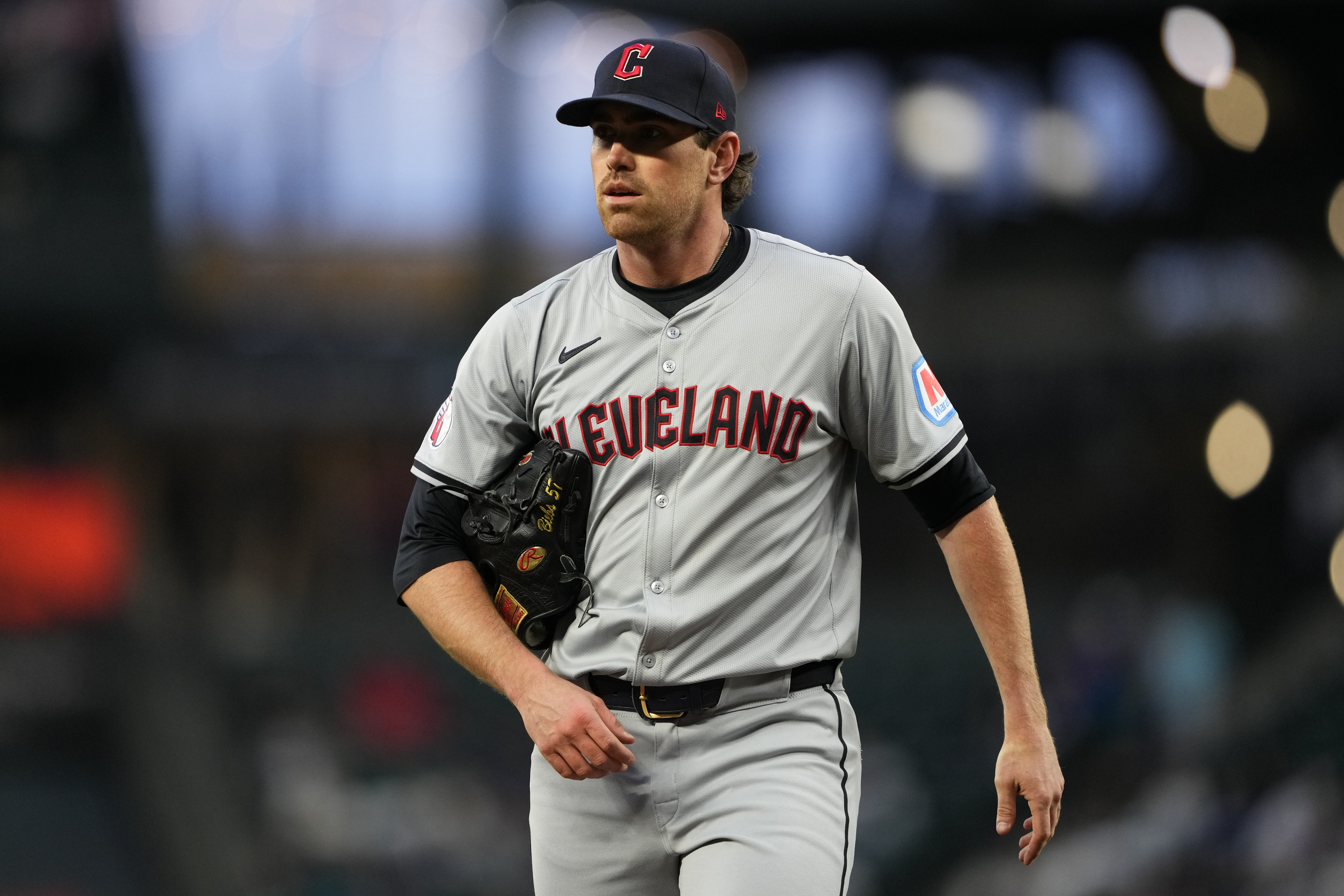 FILE - Cleveland Guardians starting pitcher Shane Bieber walks back to the dugout after throwing against the Seattle Mariners in a baseball game Tuesday, April 2, 2024, in Seattle. Cleveland's ace will have season-ending Tommy John elbow surgery, a major blow to the Guardians and the 2020 Cy Young winner, who had looked like his dominant self in two strong recent starts. 