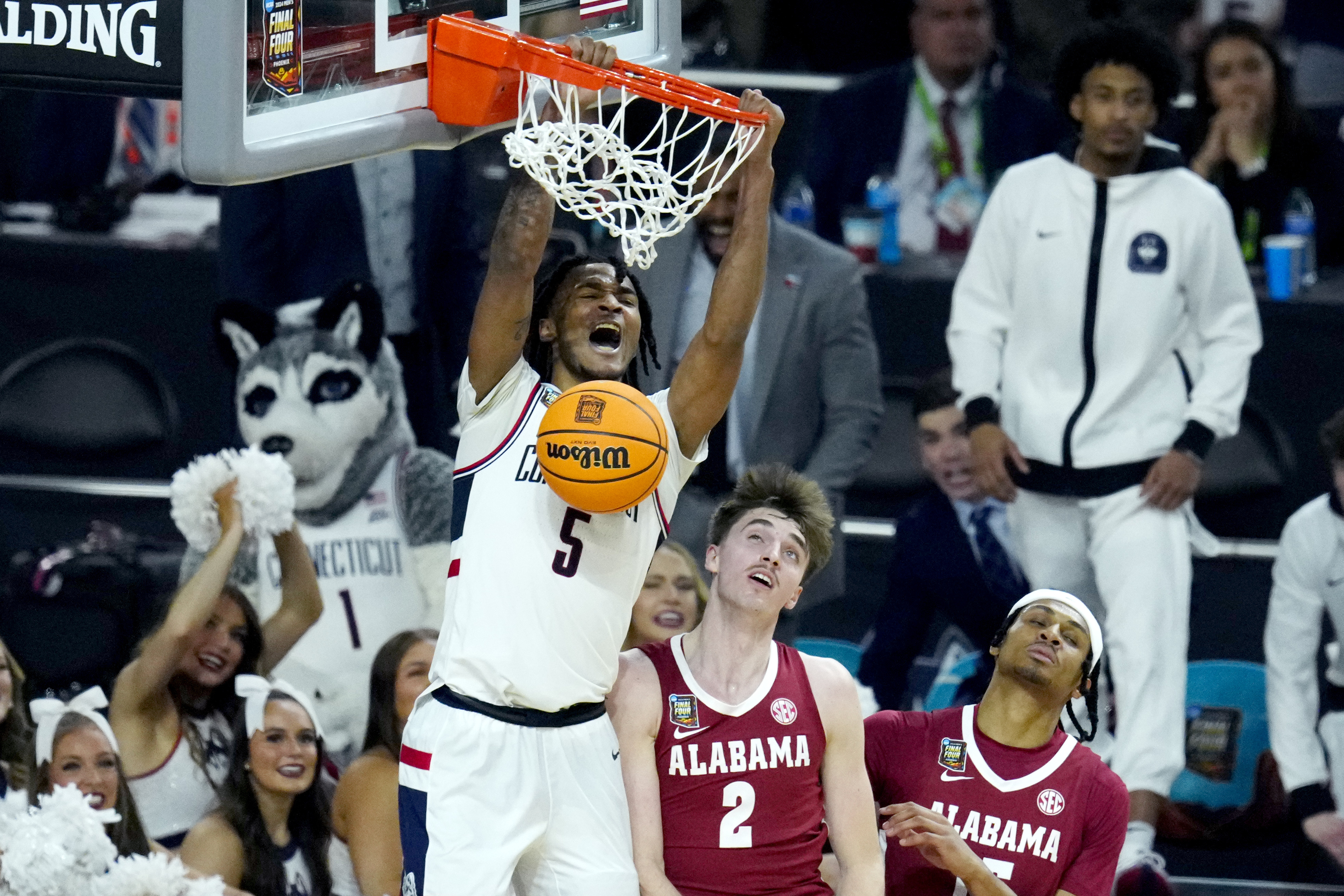 UConn guard Stephon Castle (5) dunks over Alabama forward Grant Nelson (2) during the second half of the NCAA college basketball game at the Final Four, Saturday, April 6, 2024, in Glendale, Ariz. 