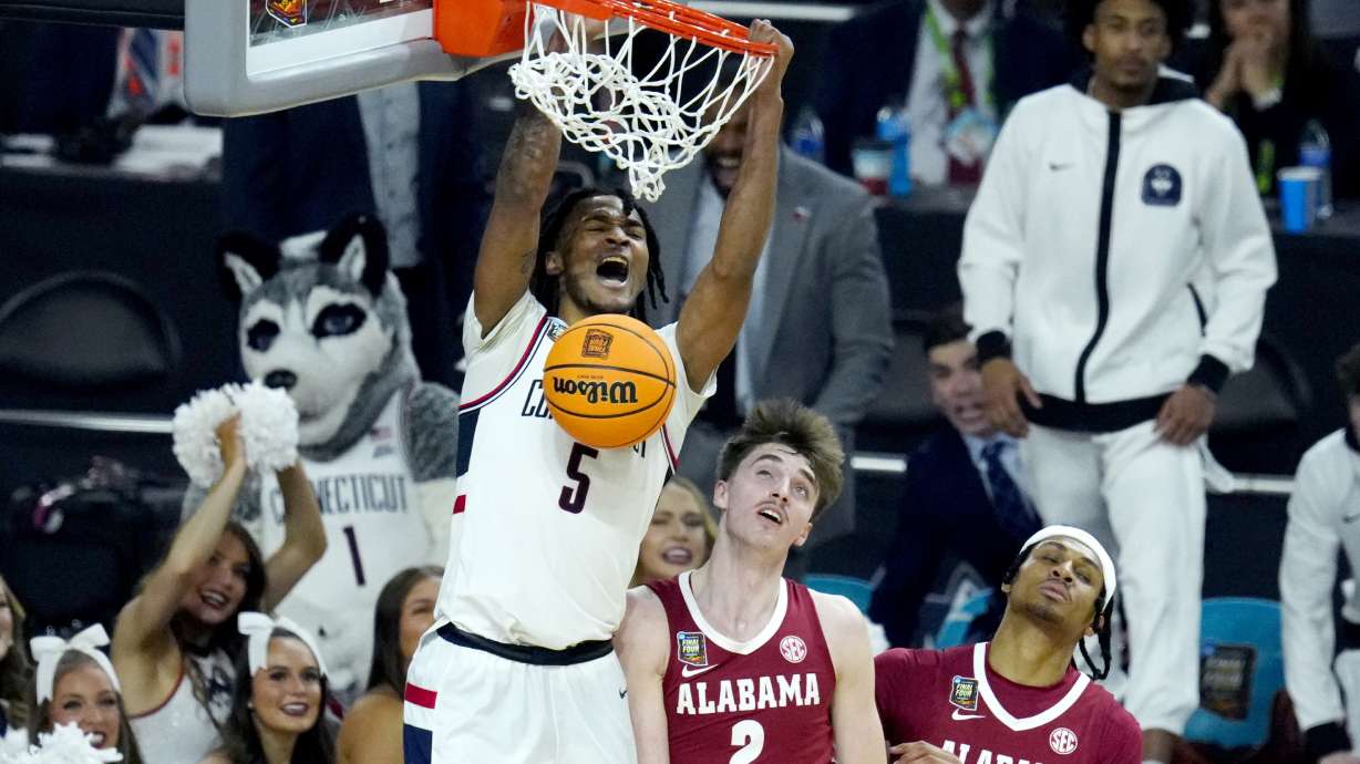 UConn guard Stephon Castle (5) dunks over Alabama forward Grant Nelson (2) during the second half of the NCAA college basketball game at the Final Four, Saturday, April 6, 2024, in Glendale, Ariz.