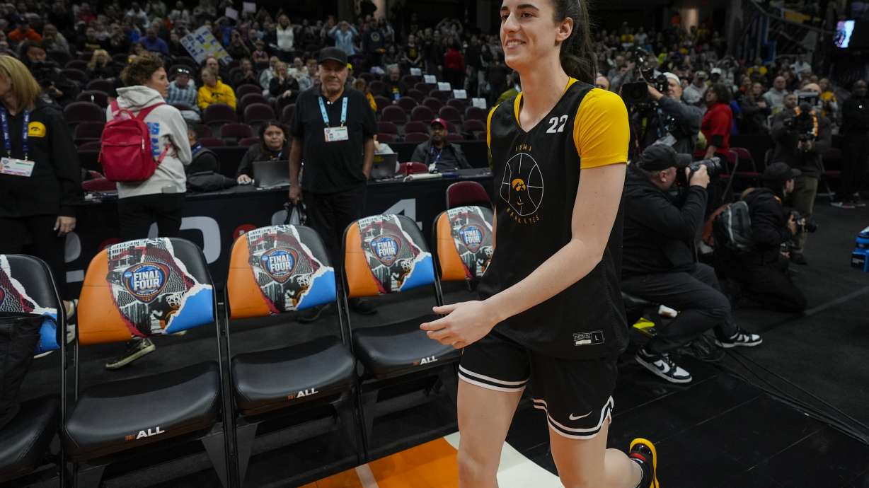 Iowa's Caitlin Clark smiles as she arrives for practice for the NCAA Women's Final Four championship basketball game Saturday, April 6, 2024, in Cleveland.