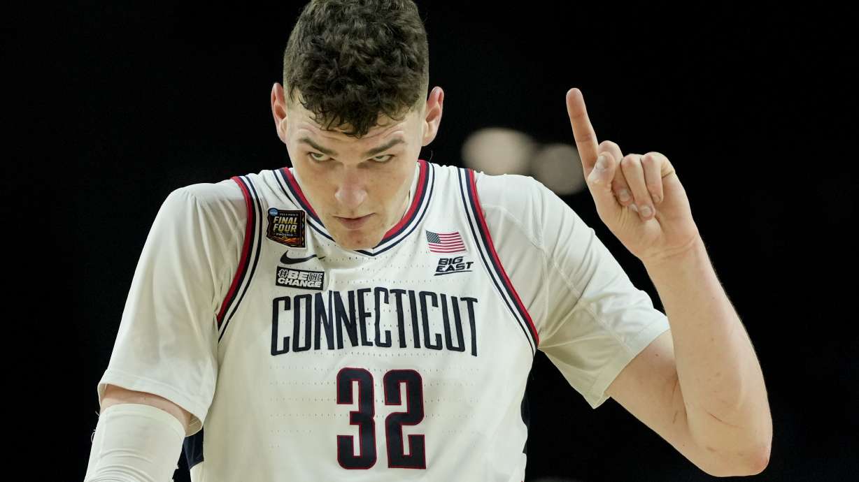 UConn center Donovan Clingan (32) celebrates after their win against Alabama in a NCAA college basketball game at the Final Four, Saturday, April 6, 2024, in Glendale, Ariz.