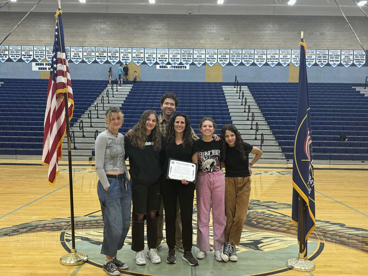 Jennifer Hughes with her husband Corom Hughes and their four daughters on March 22 when she was sworn in as a member of the Utah National Guard at Salem Hills High School.