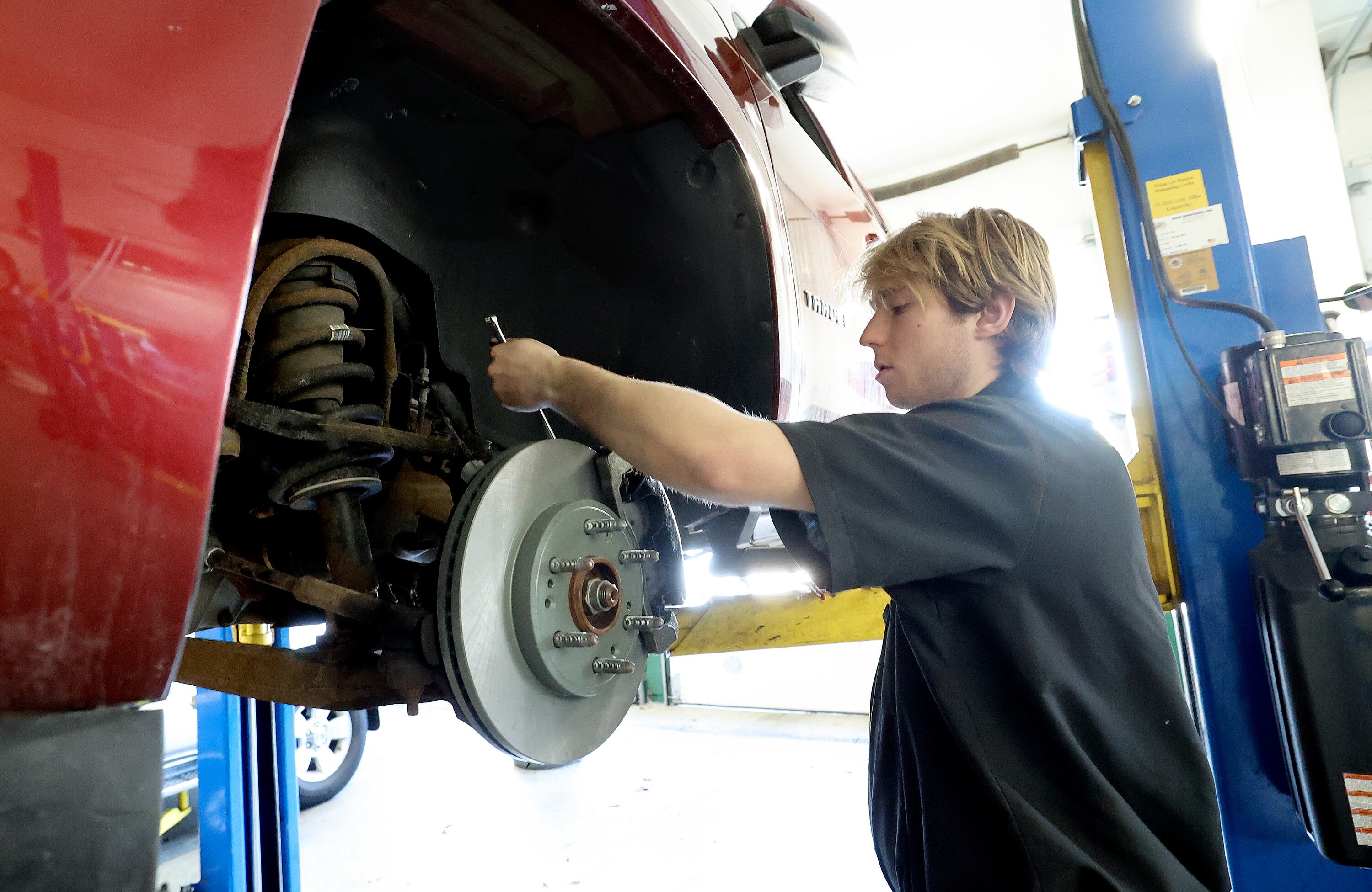 Seth Plowgian works at Plowgian Auto Repair in Millcreek on March 18. The business has been in the family for five generations and he works with his father and grandfather.