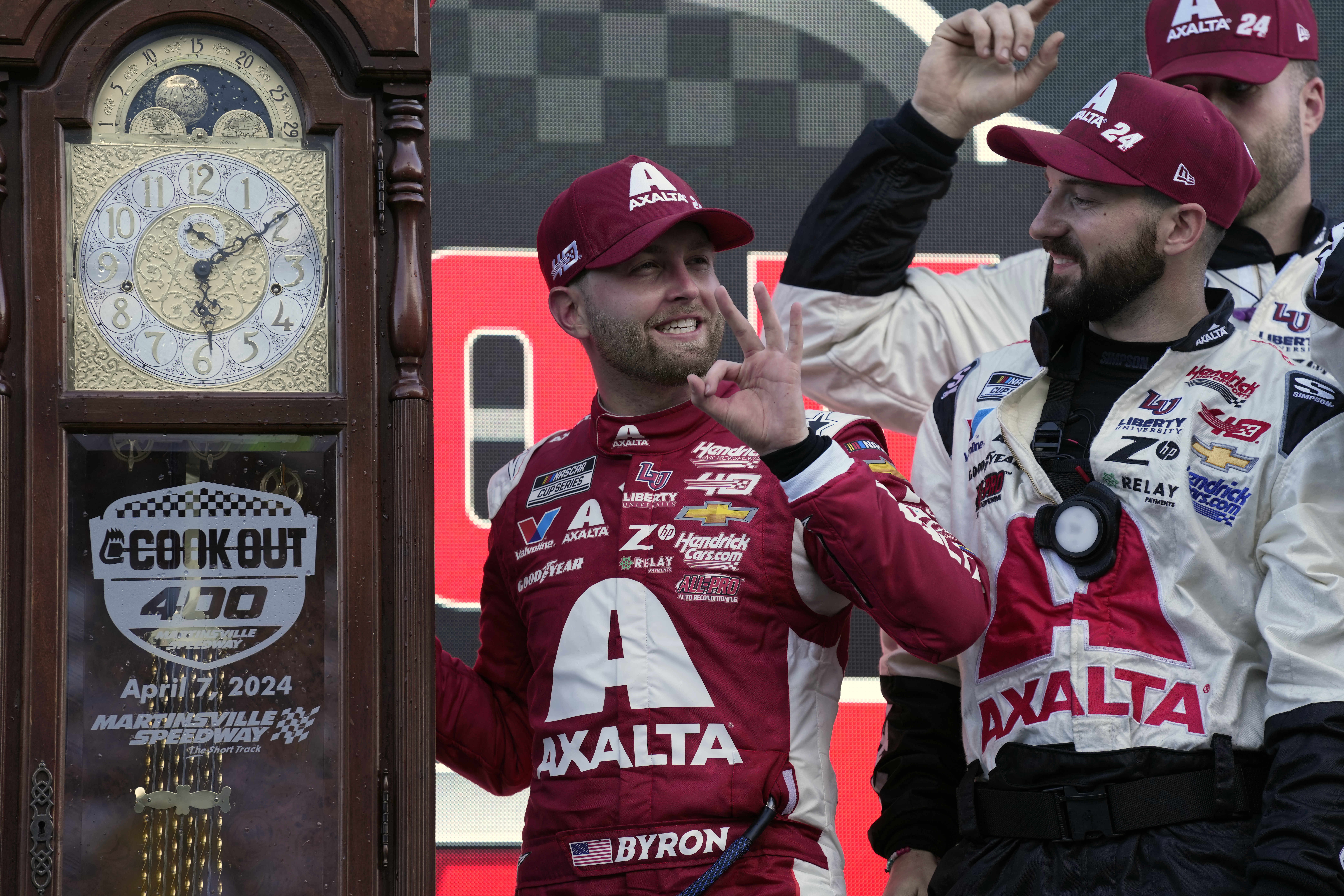 William Byron, center, celebrates with crew members in Victory Lane after receiving the trophy for winning the NASCAR Cup Series auto race at Martinsville Speedway in Martinsville, Va., Sunday, April 7, 2024. 