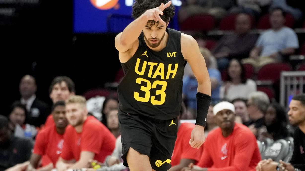 Utah Jazz guard Johnny Juzang (33) reacts after making a three-point basket against the Houston Rockets during the first half of an NBA basketball game Saturday, March 23, 2024, in Houston. (AP Photo/Eric Christian Smith)