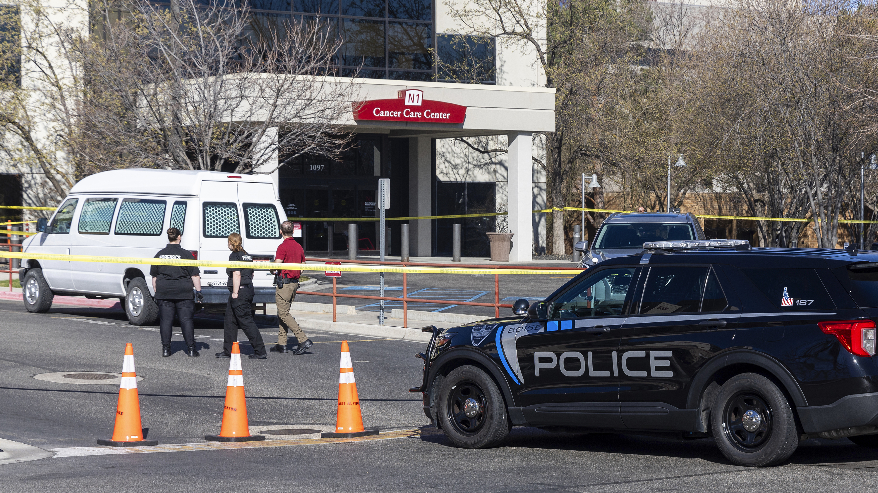 A police vehicle is parked outside Saint Alphonsus Regional Medical Center in Boise, Idaho, on March 20. Two members of an Idaho white supremacist prison gang, an inmate and the man accused of helping him escape in an armed ambush at the hospital are due in court Monday.