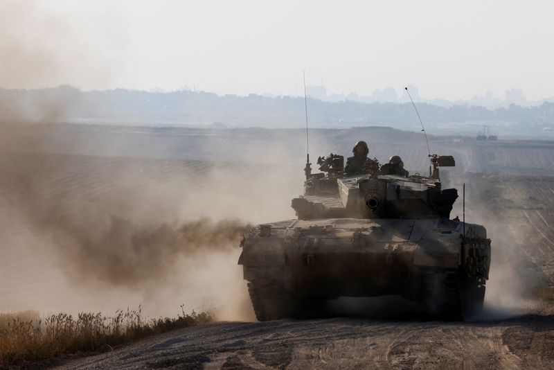 Israeli tank maneuvers near Israel's border with Gaza, amid the ongoing conflict between Israel and the Palestinian Islamist group Hamas, in southern Israel, Sunday.