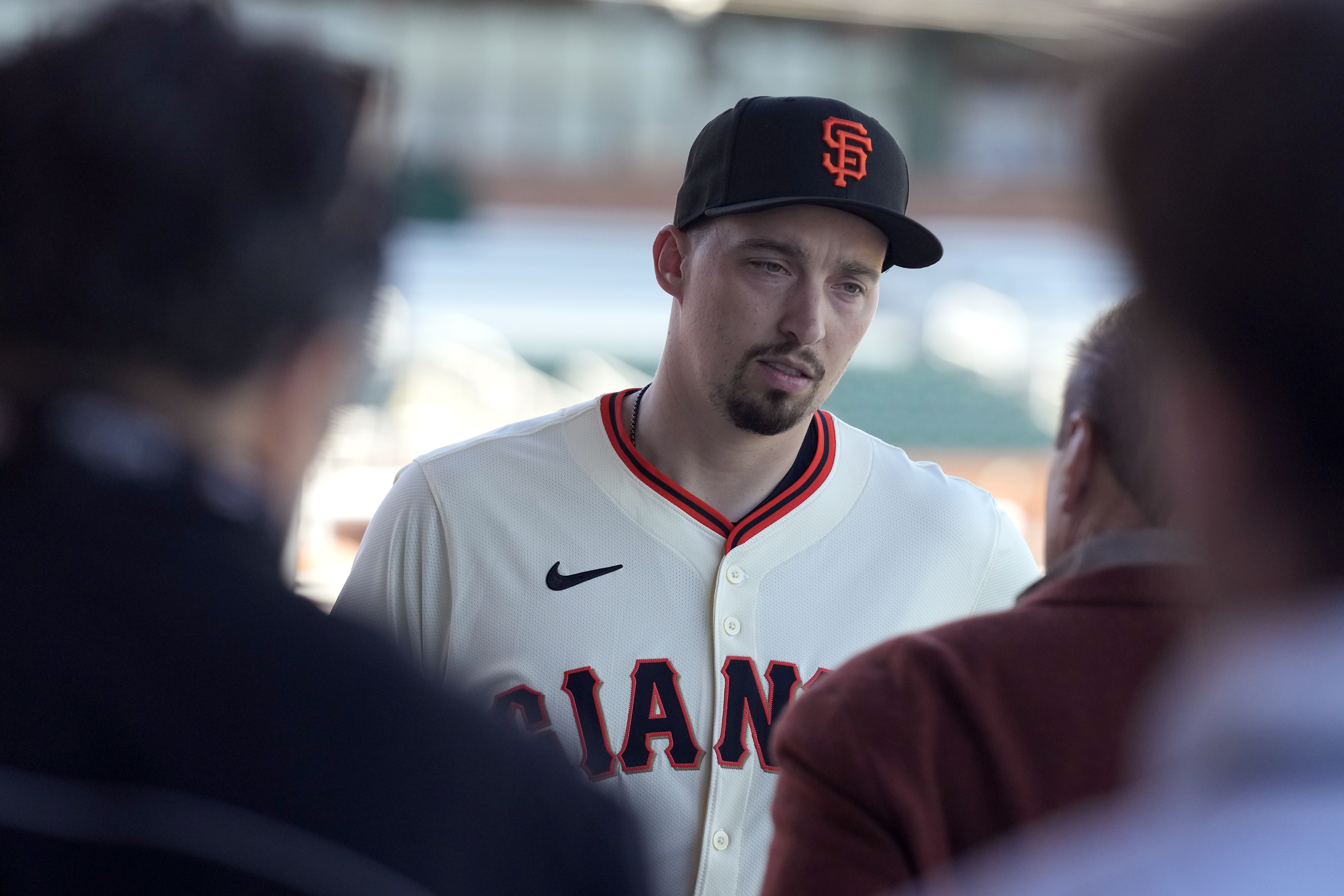 New San Francisco Giants pitcher Blake Snell speaks to agent Scott Boras after Blake was introduced during a baseball news conference, Wednesday, March 20, 2024, in Scottsdale, Ariz.