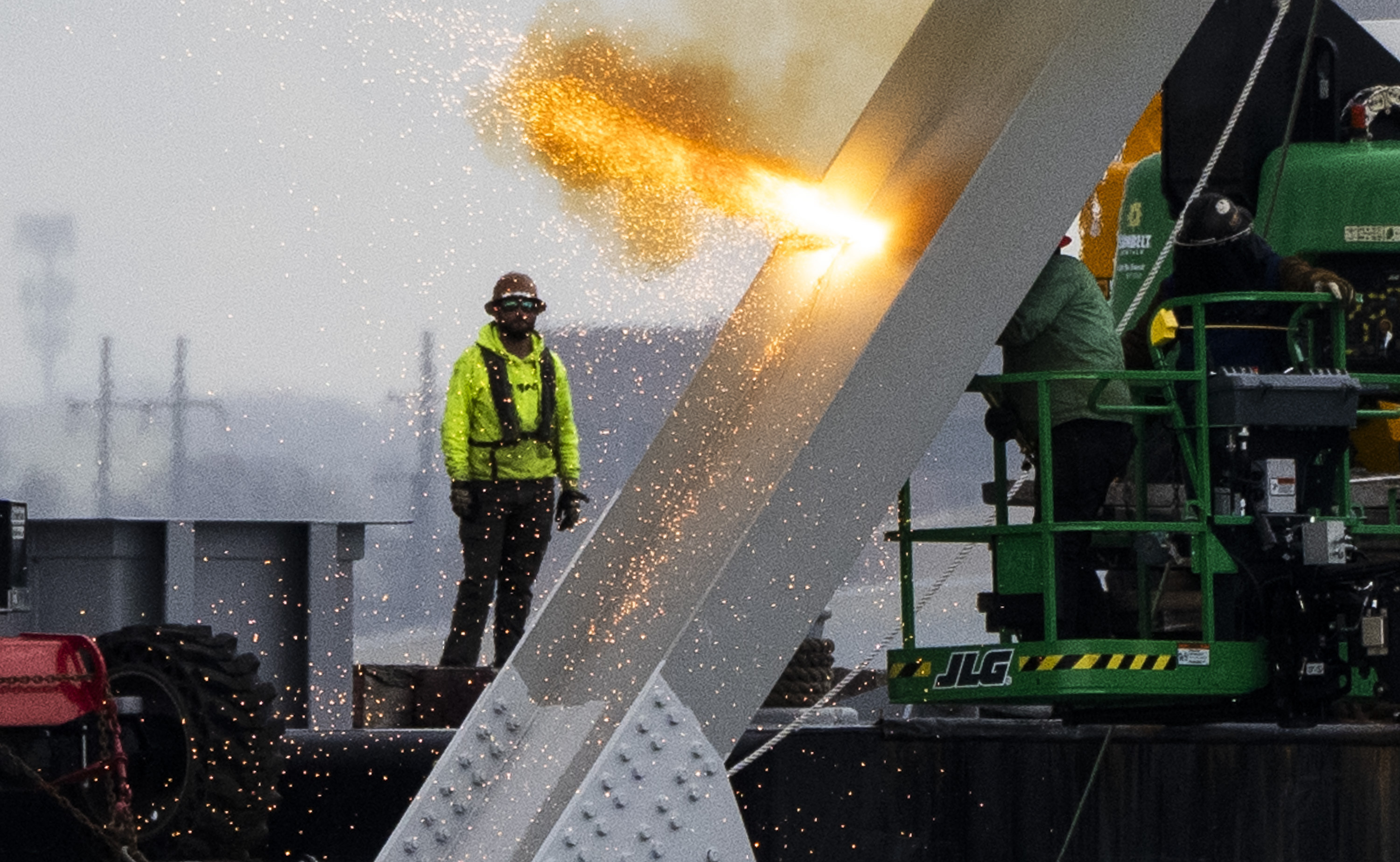 Workers are seen in the beginning stages of dismantling the steel from the frame of the collapsed Francis Scott Key Bridge, using an exothermic cutting torch, April 4, in Baltimore. 