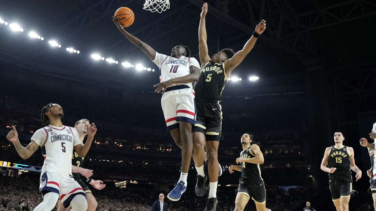 UConn guard Hassan Diarra (10) shoots past Purdue guard Myles Colvin during the second half of the NCAA college Final Four championship basketball game, Monday, April 8, 2024, in Glendale, Ariz.