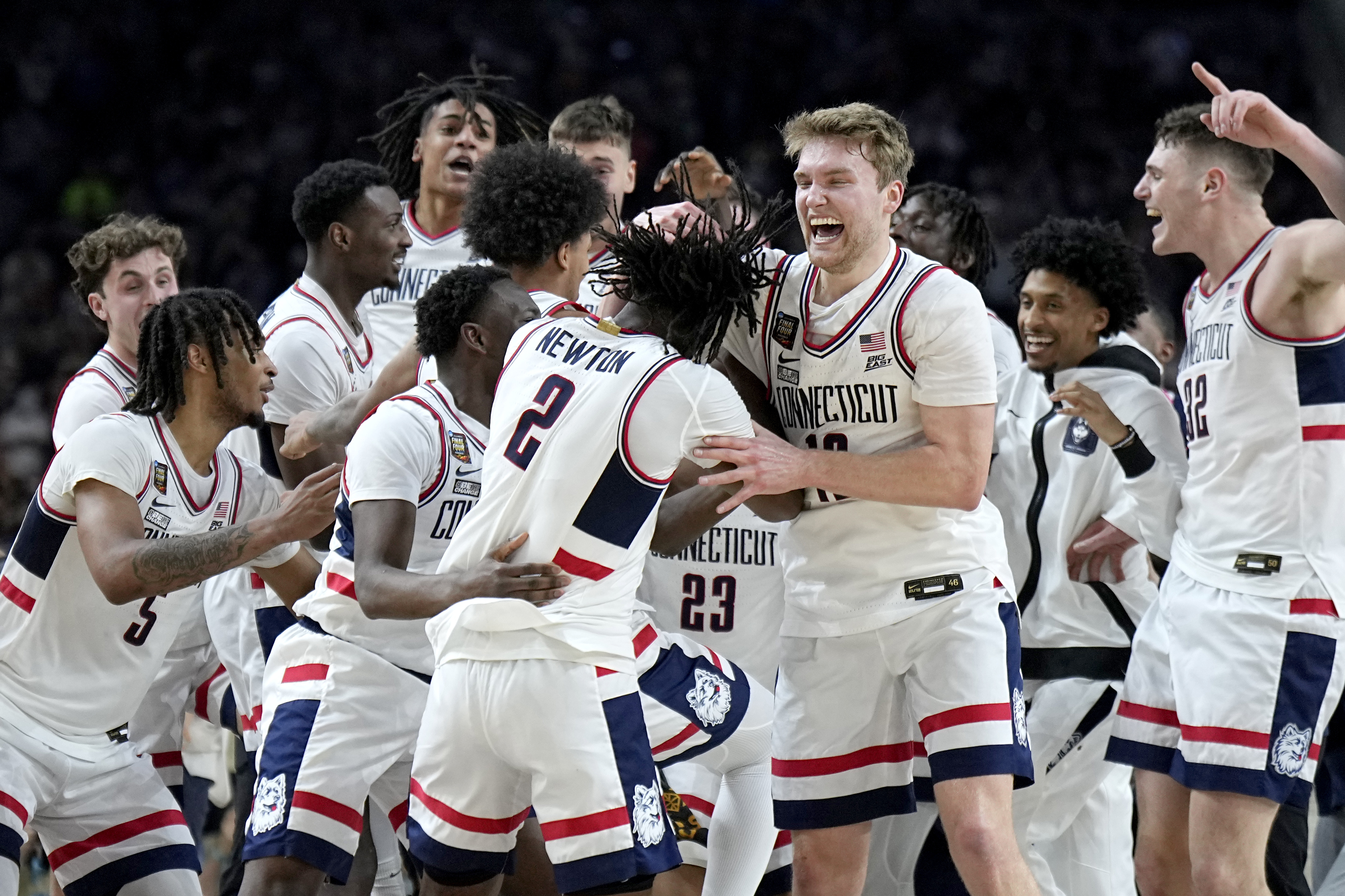 UConn players celebrate as time expires during the second half of the NCAA college Final Four championship basketball game against Purdue, Monday, April 8, 2024, in Glendale, Ariz. 