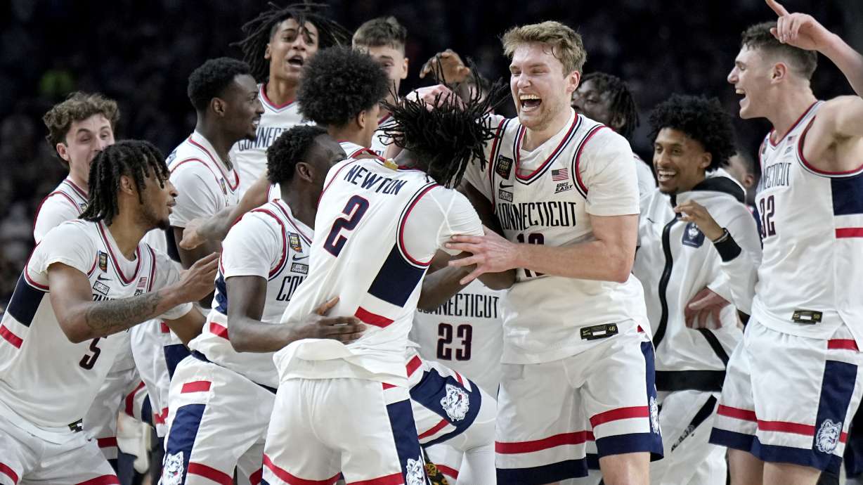 UConn players celebrate as time expires during the second half of the NCAA college Final Four championship basketball game against Purdue, Monday, April 8, 2024, in Glendale, Ariz.