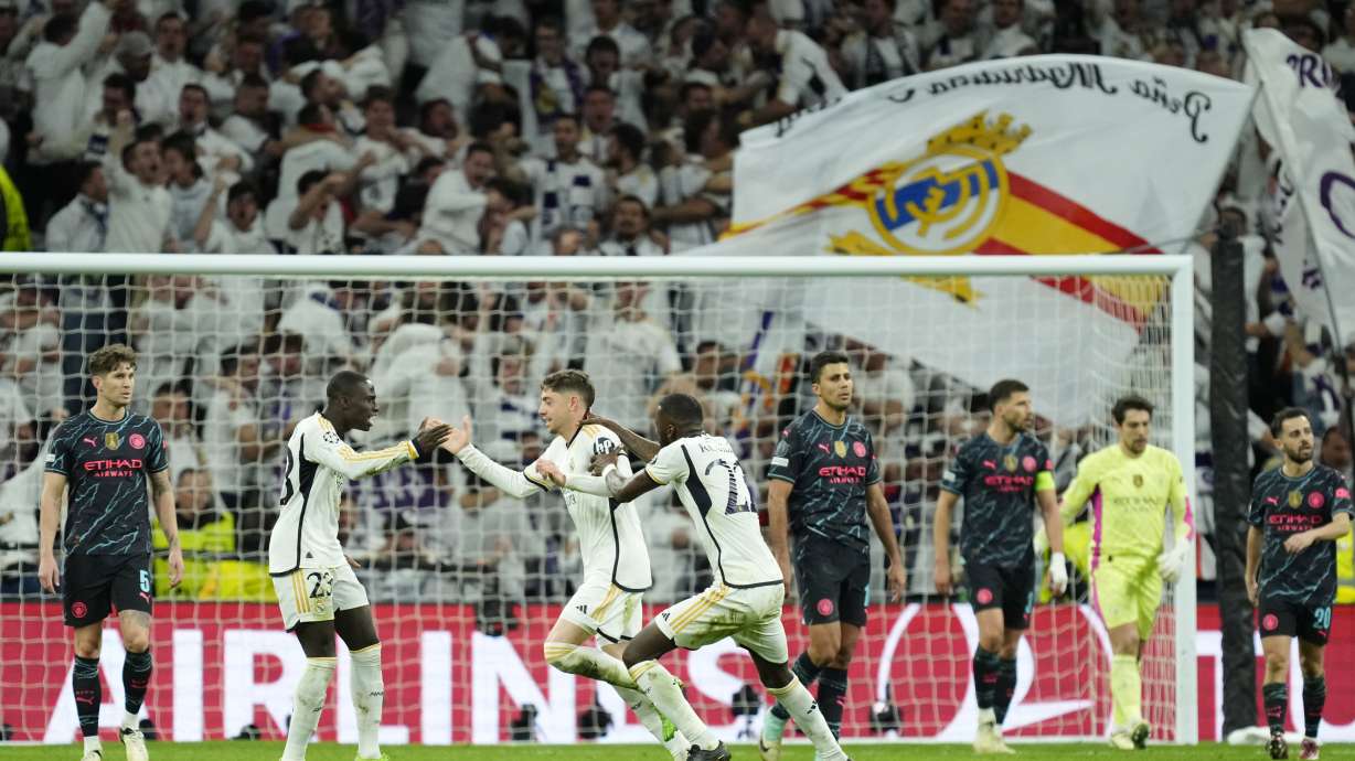 Real Madrid's Federico Valverde, third left, celebrates with his teammates after scoring his side's third goal during the Champions League quarterfinal first leg soccer match between Real Madrid and Manchester City at the Santiago Bernabeu stadium in Madrid, Spain, Tuesday, April 9, 2024.