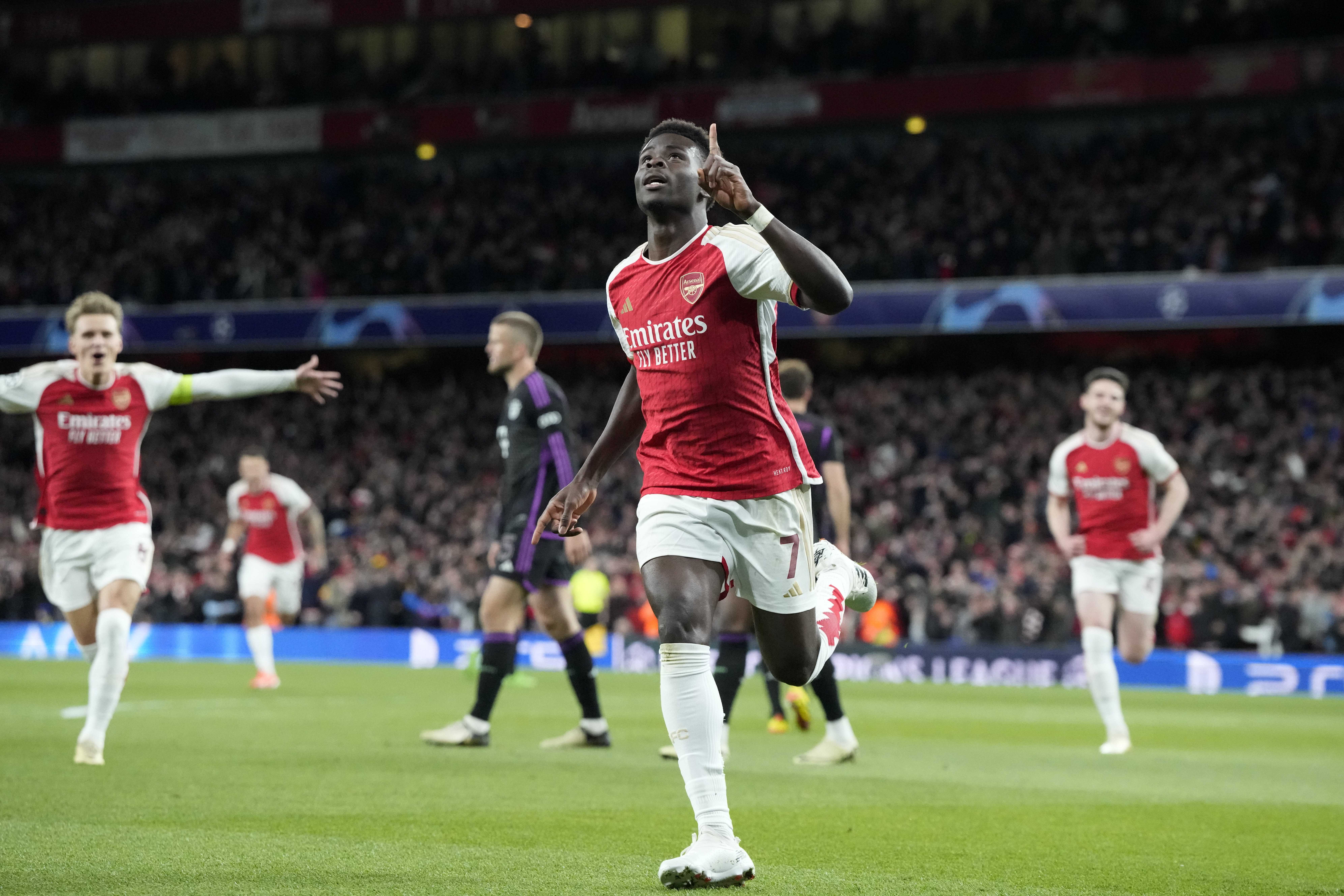 Arsenal's Bukayo Saka celebrates after he scored the opening goal during the Champions League quarter final first leg soccer match between Arsenal and Bayern Munich at the Emirates Stadium, London, Tuesday, April 9, 2024. 