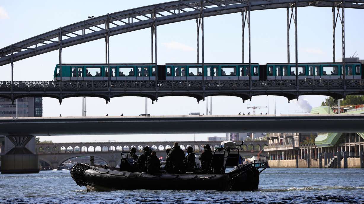 Members of the police squad RAID sit in an inflatable boat during an operational test for the Paris 2024 Olympic Games opening ceremony, July 17, 2023, in Paris. The ceremonies are still going to be held on the Seine River, organizers said.