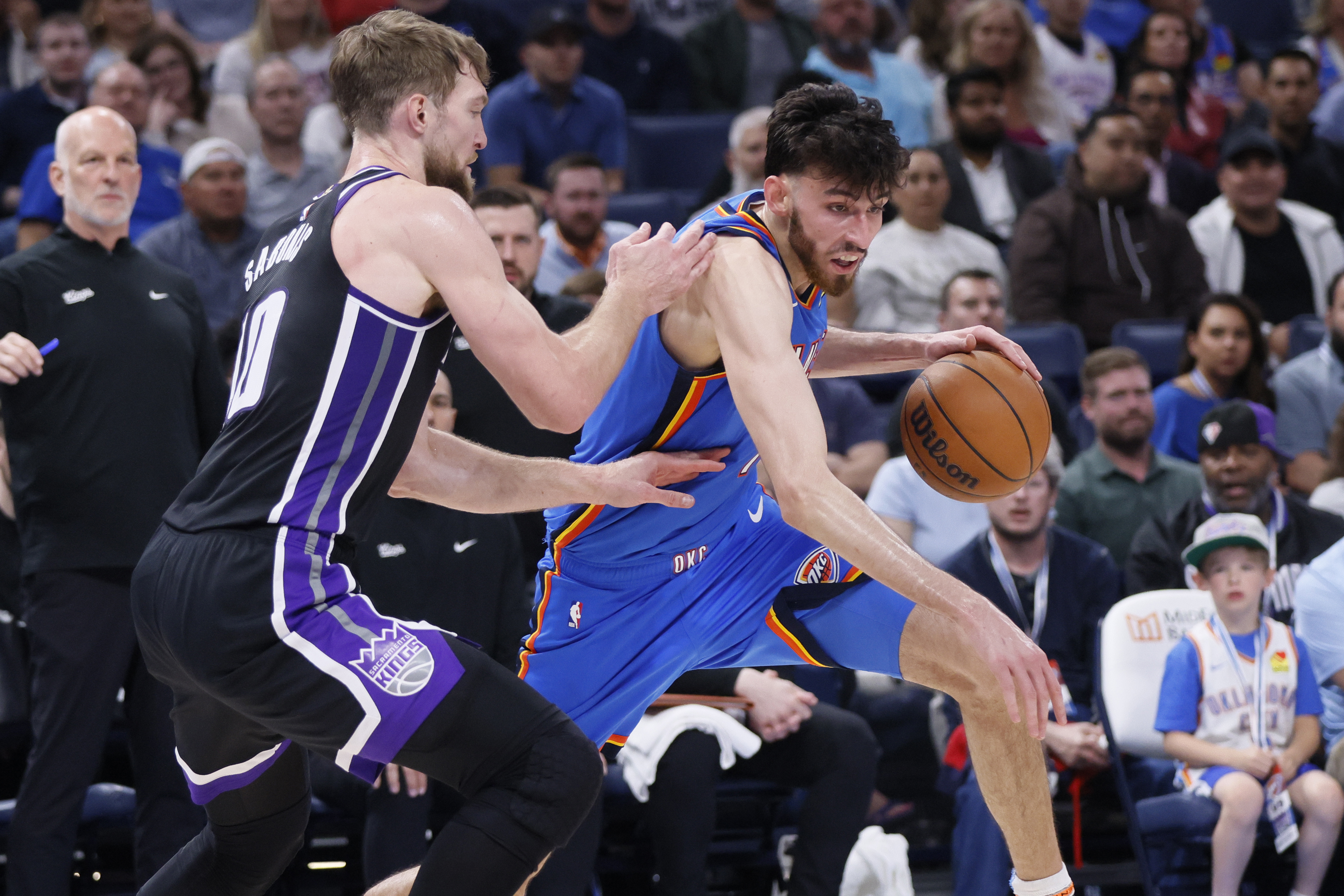 Oklahoma City Thunder forward Chet Holmgren, right, drives against Sacramento Kings forward Domantas Sabonis during the second half of an NBA basketball game Tuesday, April 9, 2024, in Oklahoma City. 