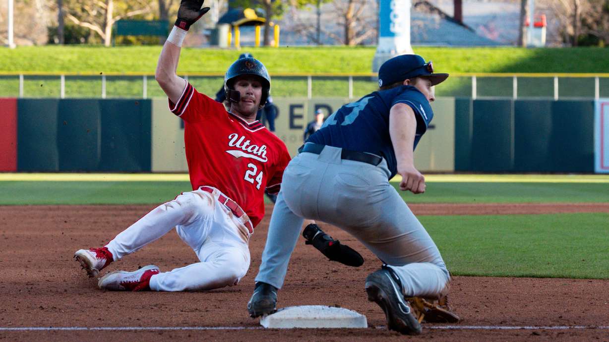 Utah Utes Kai Roberts (24) slides into third base and is tagged out by Brigham Young Cougars infielder Easton Jones (17) during a college baseball game between the Utah Utes and the Brigham Young Cougars at Smith's Ballpark in Salt Lake City on Tuesday, April 9, 2024.