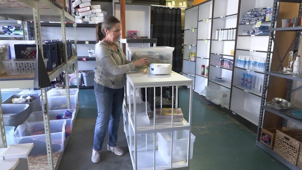 Lucy Anderson restocks items at Catholic Community Services Sharehouse in Salt Lake City on Tuesday.