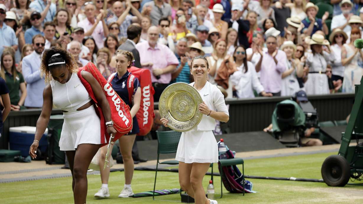 FILE - Romania's Simona Halep walks away with her trophy after defeating United States' Serena Williams, left, in the women's singles final match on day twelve of the Wimbledon Tennis Championships in London, Saturday, July 13, 2019. Halep tells The Associated Press she was nervous while flying to her first tennis tournament in 1 1/2 years. She thought her career might be finished when she was given a four-year penalty by the International Tennis Integrity Agency after testing positive for the banned drug Roxadustat at the 2022 U.S. Open, where she lost in the first round.