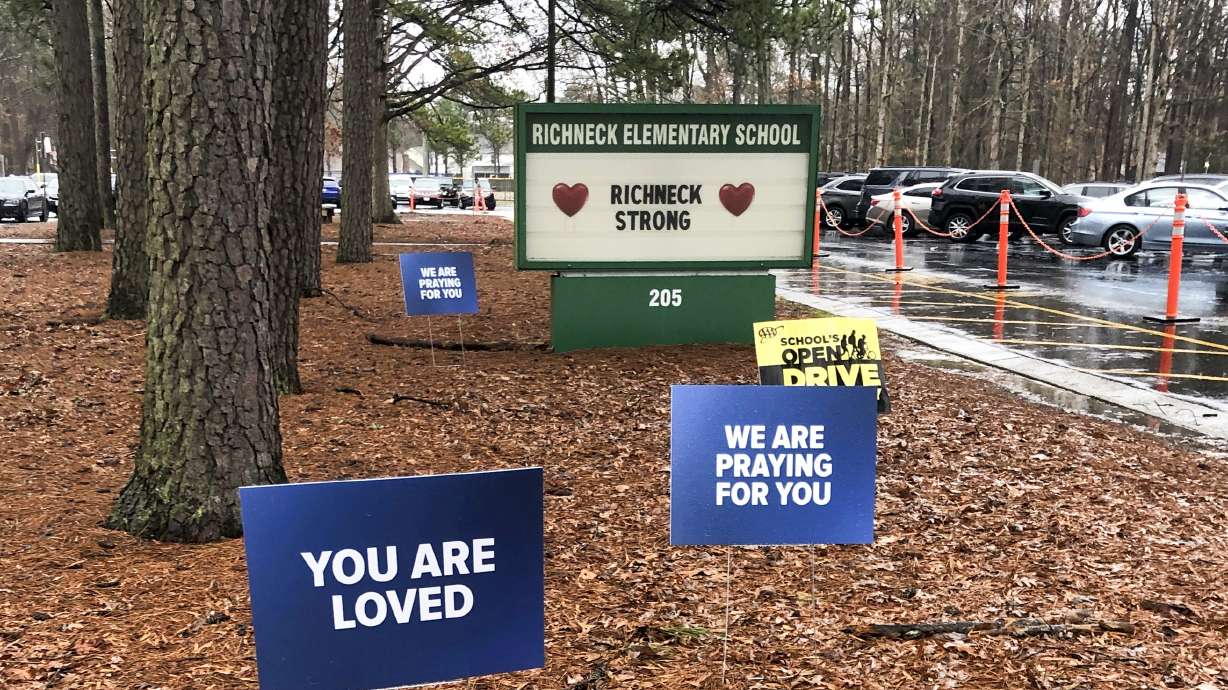 Signs stand outside Richneck Elementary School in Newport News, Va., Jan. 25, 2023. A former assistant principal at a Virginia elementary school has been indicted on eight felony counts of child neglect in the case of a 6-year-old boy who shot and wounded his first-grade teacher in Newport News, Virginia, last year.