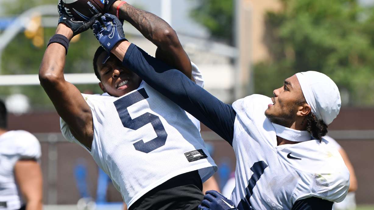Wide receiver Darius Lassiter and tight end Keanu Hill have fun catching and defending as quarterback Kedon Slovis tosses the ball up for them after BYU fall practice in Provo on Tuesday, Aug. 8, 2023.