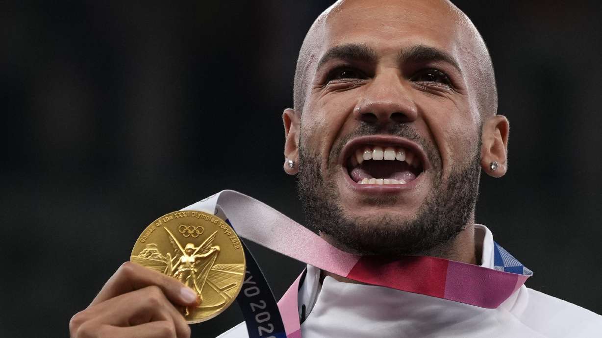 FILE - Lamont Marcell Jacobs, of Italy poses with his gold medal following the men's 100-meters final at the 2020 Summer Olympics, Monday, Aug. 2, 2021, in Tokyo. Track and field is set to become the first sport to introduce prize money at the Olympics, with World Athletics saying Wednesday, April 10, 2024, it would pay $50,000 to gold medalists in Paris.