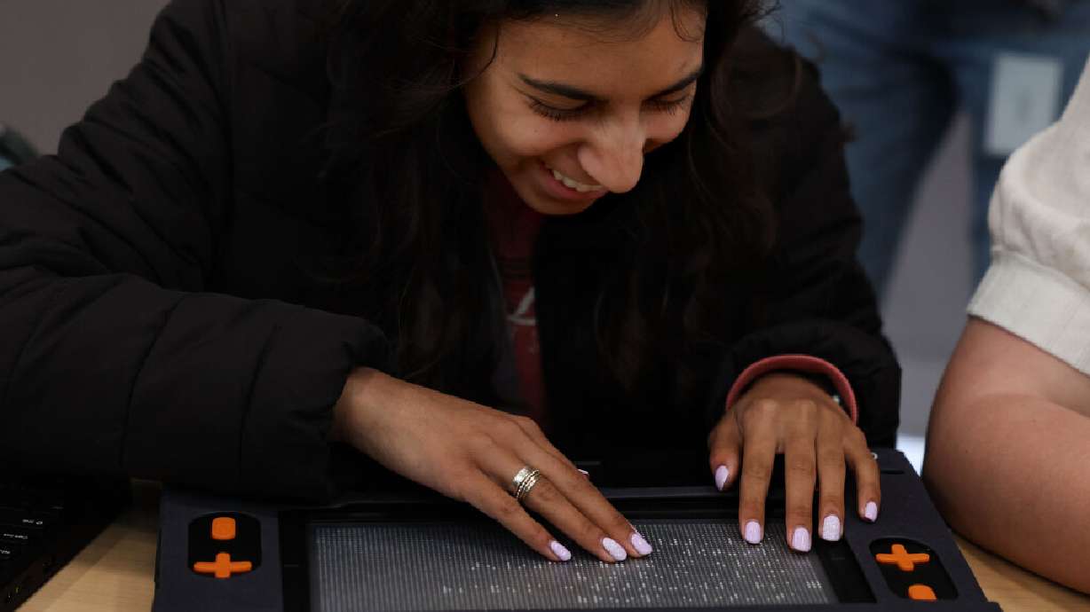Kalinka Brown, a ninth grader at HighMark Charter School, uses the Monarch, a multiline Braille display, at the Utah Schools for the Deaf and the Blind in Salt Lake City on Wednesday.