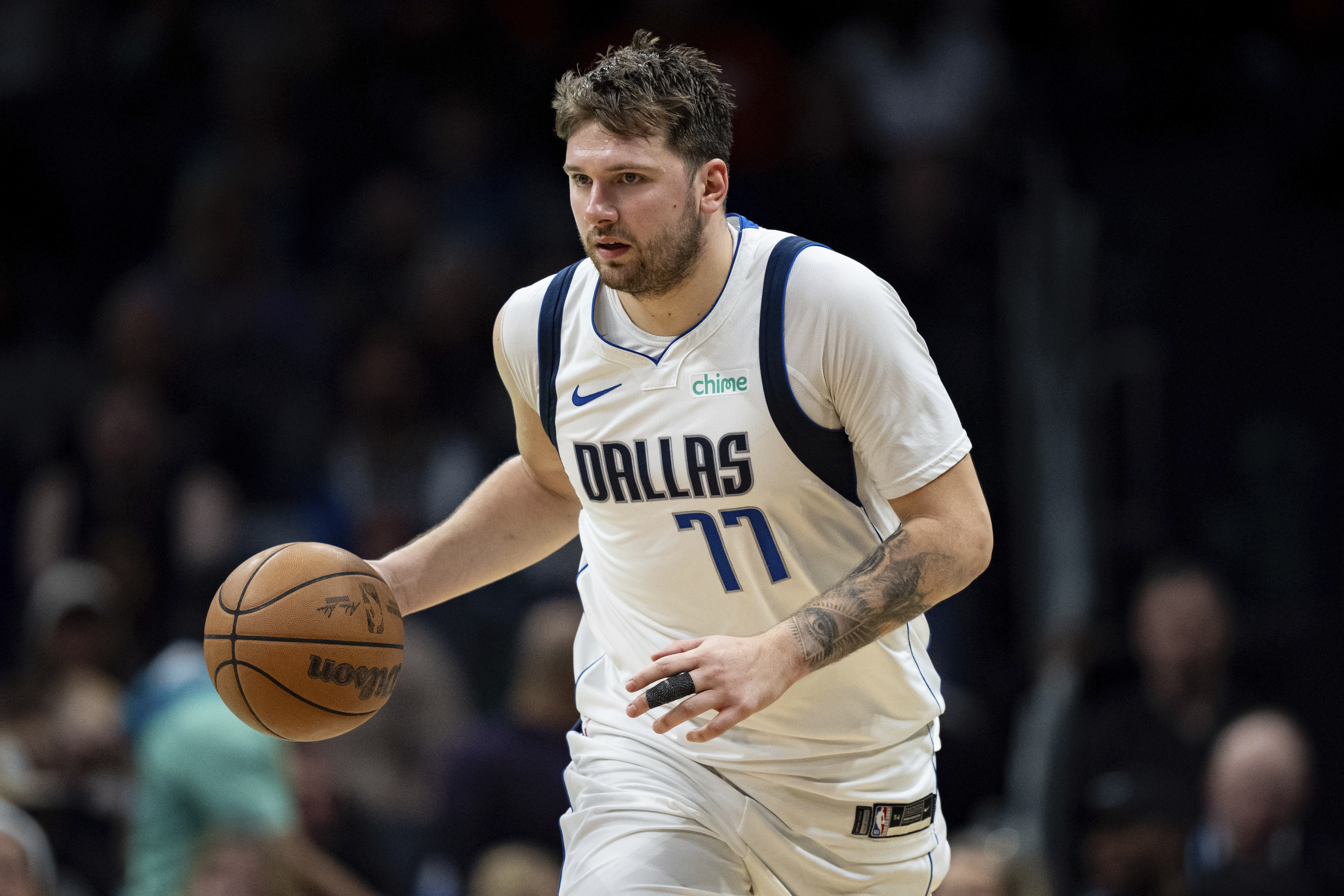 Dallas Mavericks guard Luka Doncic (77) brings the ball upcourt during the second half of an NBA basketball game against the Charlotte Hornets Tuesday, April 9, 2024, in Charlotte, N.C. 