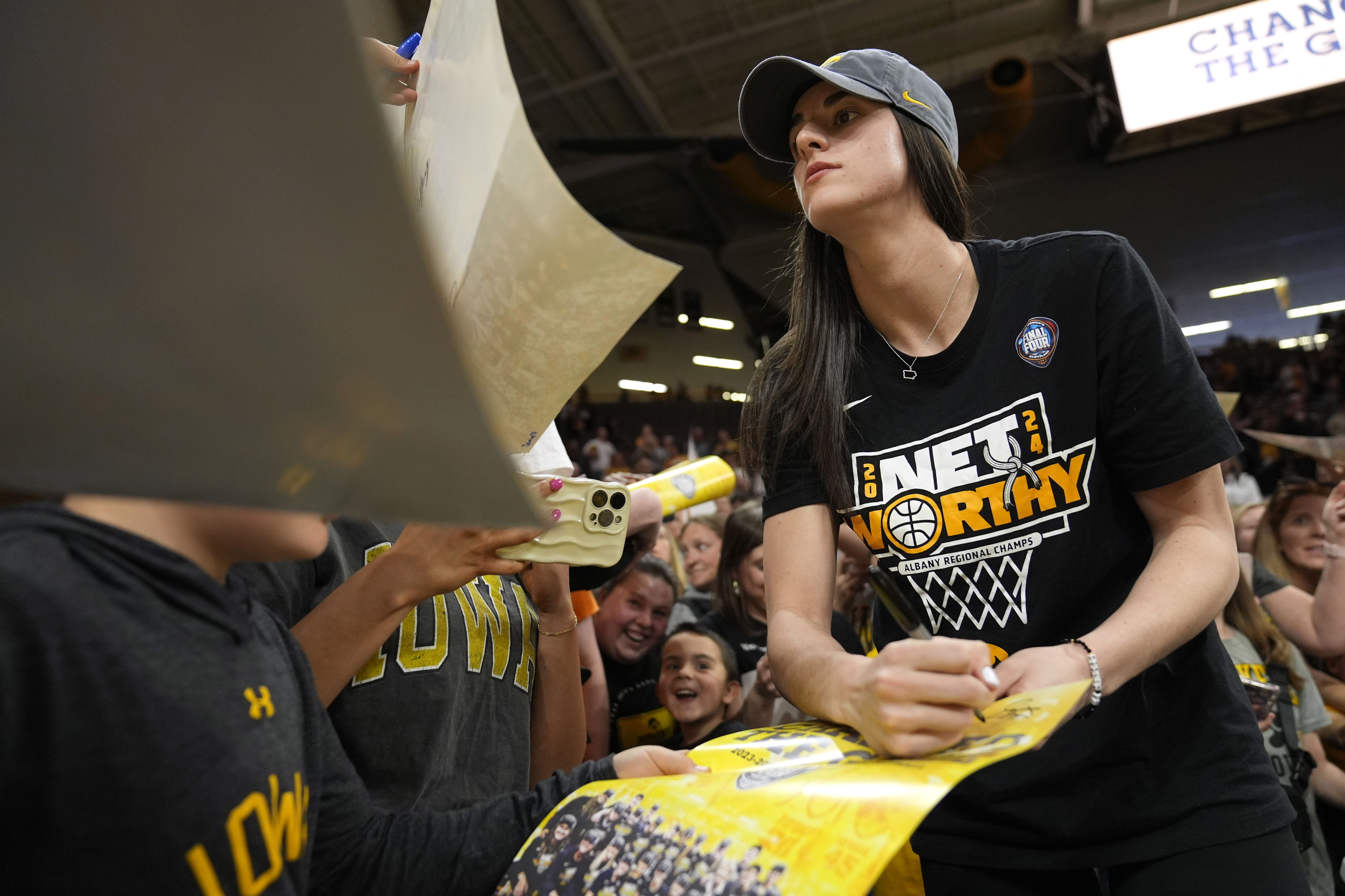 Iowa guard Caitlin Clark signs autographs during an Iowa women's basketball team celebration, Wednesday, April 10, 2024, in Iowa City, Iowa. Iowa lost to South Carolina in the Final Four college basketball championship game of the women's NCAA Tournament on Sunday. 