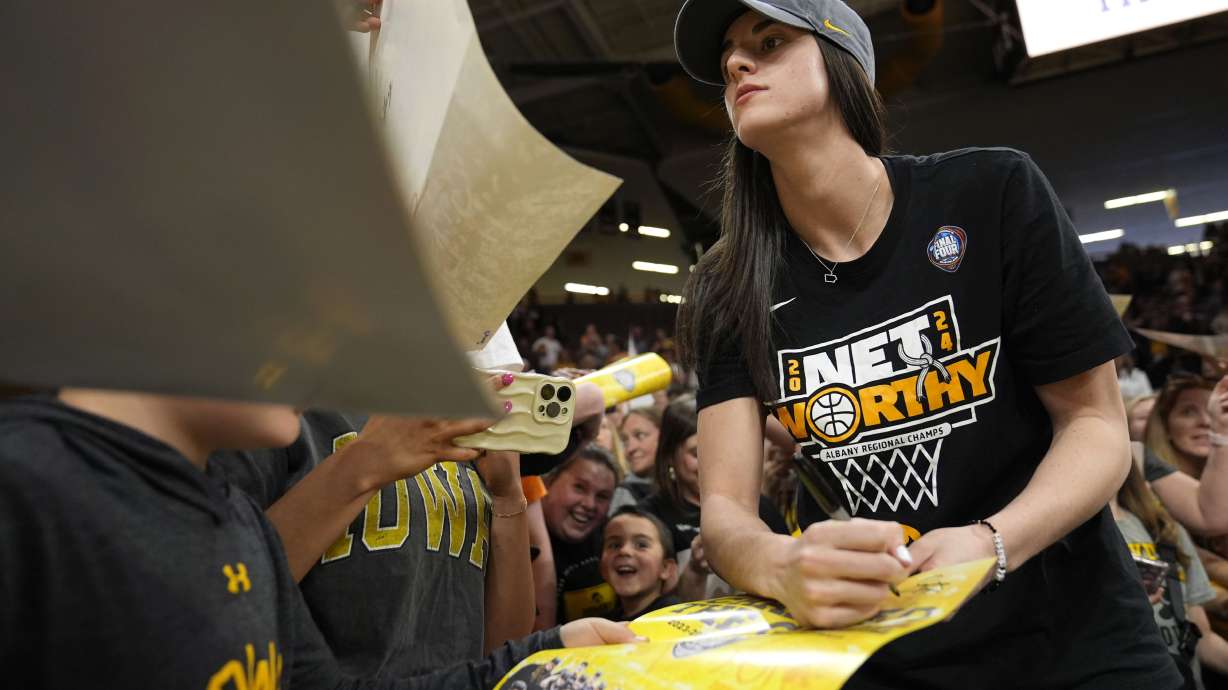 Iowa guard Caitlin Clark signs autographs during an Iowa women's basketball team celebration, Wednesday, April 10, 2024, in Iowa City, Iowa. Iowa lost to South Carolina in the Final Four college basketball championship game of the women's NCAA Tournament on Sunday.