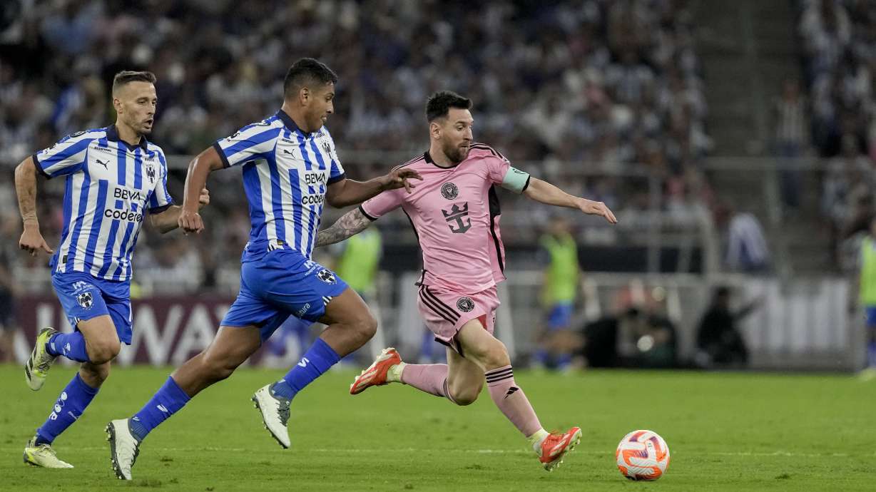 Inter Miami's Lionel Messi, right, tries control the ball past Monterrey's Luis Romo during a CONCACAF Champions Cup quarter final second leg soccer match at the BBVA stadium in Monterrey, Mexico, Wednesday, April 10, 2024.