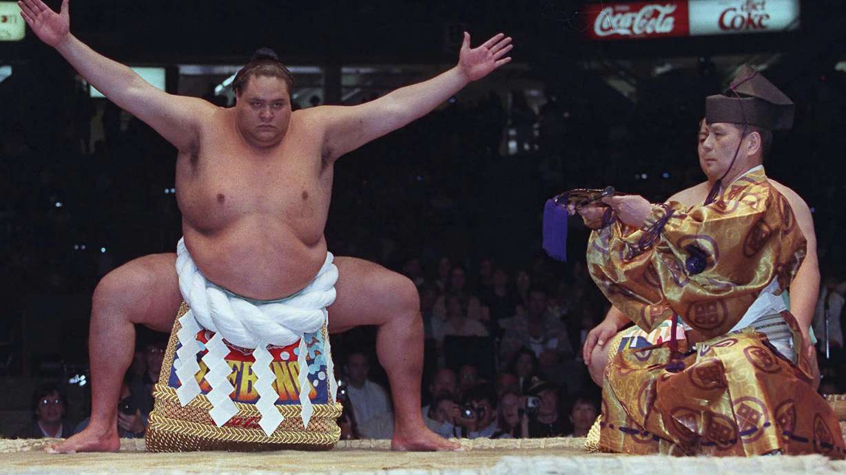 FILE - Hawaiian-born Taro Akebono, Japan's top Sumo wrestler, takes part in a ceremony in the ring prior to competition in Vancouver, British Columbia, on June 6, 1998. Hawaii-born Akebono, one of the greats of sumo wresting and a former grand champion, is reported to have died earlier this month of heart failure while receiving care at a hospital in Tokyo, the United States Forces in Japan said in a statement on Thursday, April 11, 2024.