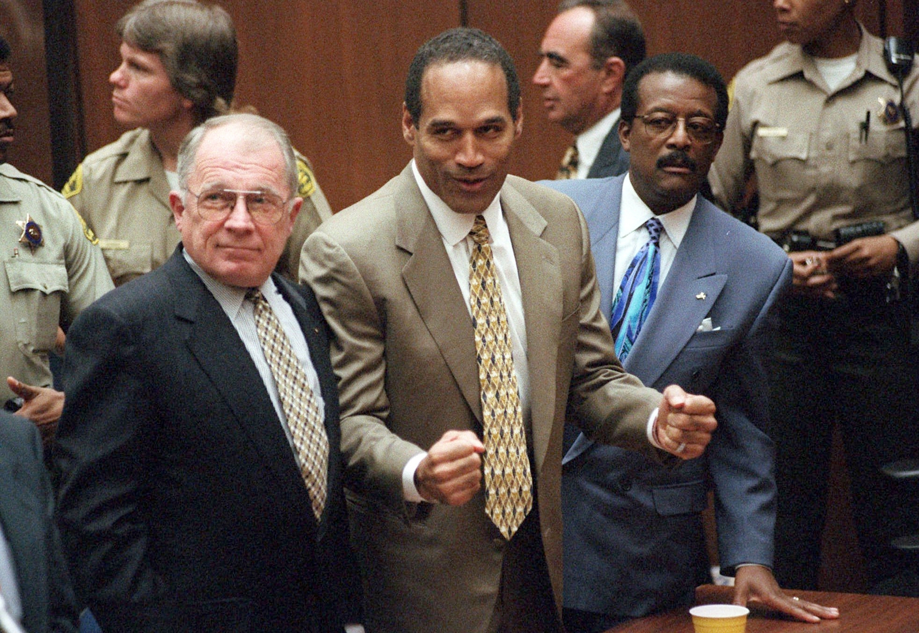 In this Oct. 3, 1995, file photo, O.J. Simpson reacts as he is found not guilty in the death of his ex-wife Nicole Brown Simpson and her friend Ron Goldman in Los Angeles. Defense attorneys F. Lee Bailey, left, and Johnnie L. Cochran Jr. stand with him. Simpson has died. He was 76.