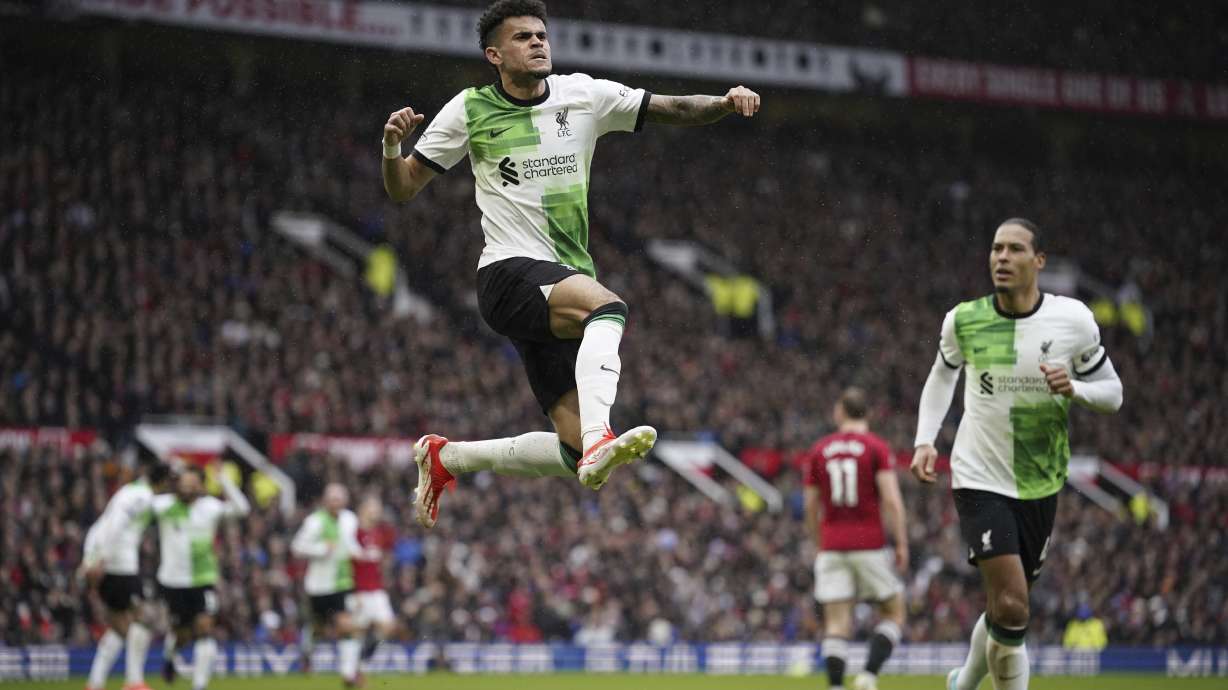 Liverpool's Luis Diaz, centre, celebrates after scoring the opening goal during the English Premier League soccer match between Manchester United and Liverpool at the Old Trafford stadium in Manchester, England, Sunday, April 7, 2024.