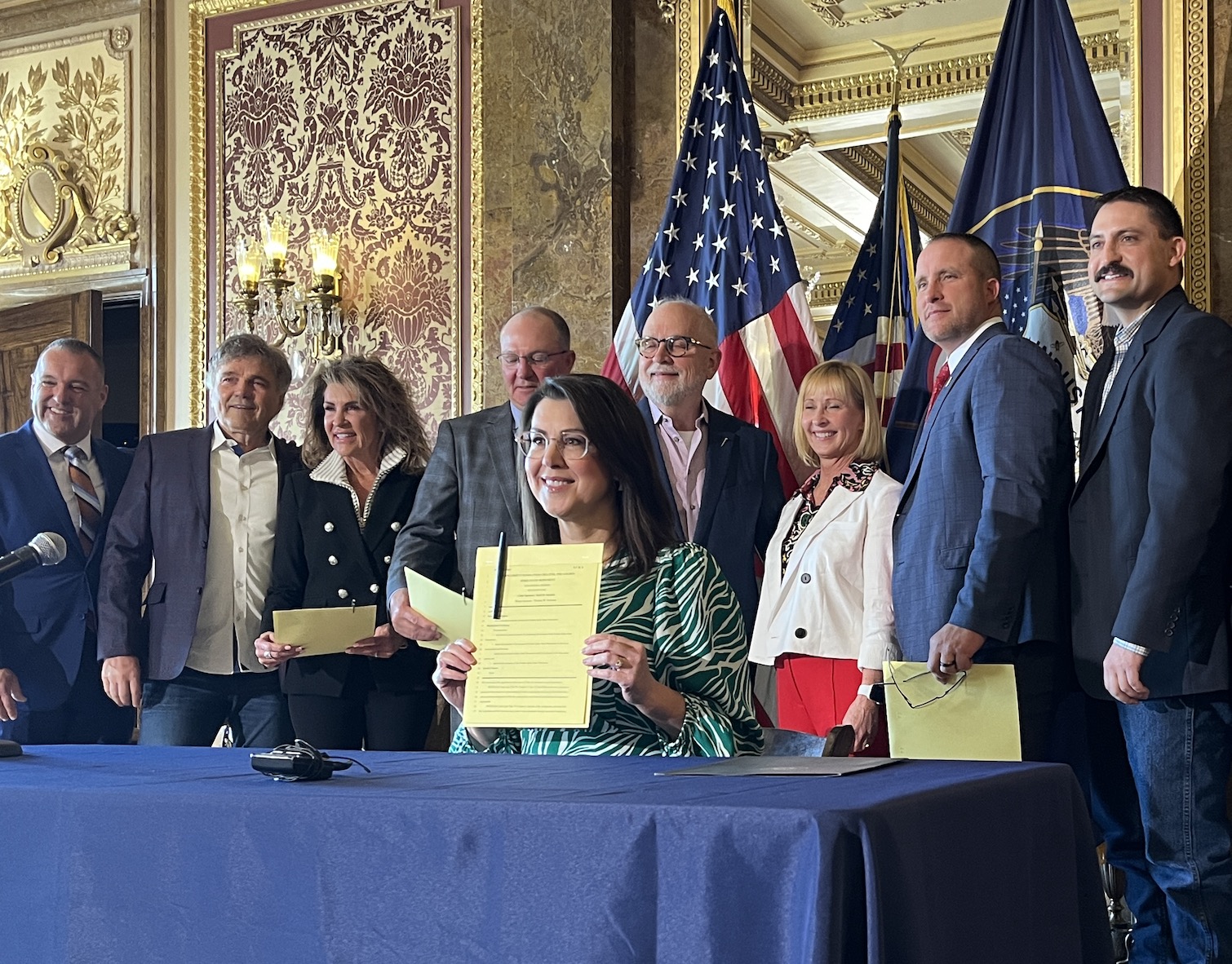 Lt. Gov. Deidre Henderson, center, holds up a copy of SCR6 after a ceremonial signing of the bill at the Utah Capitol's Gold Room on Thursday. The bill designates the Golden Spike State Monument in Brigham City.