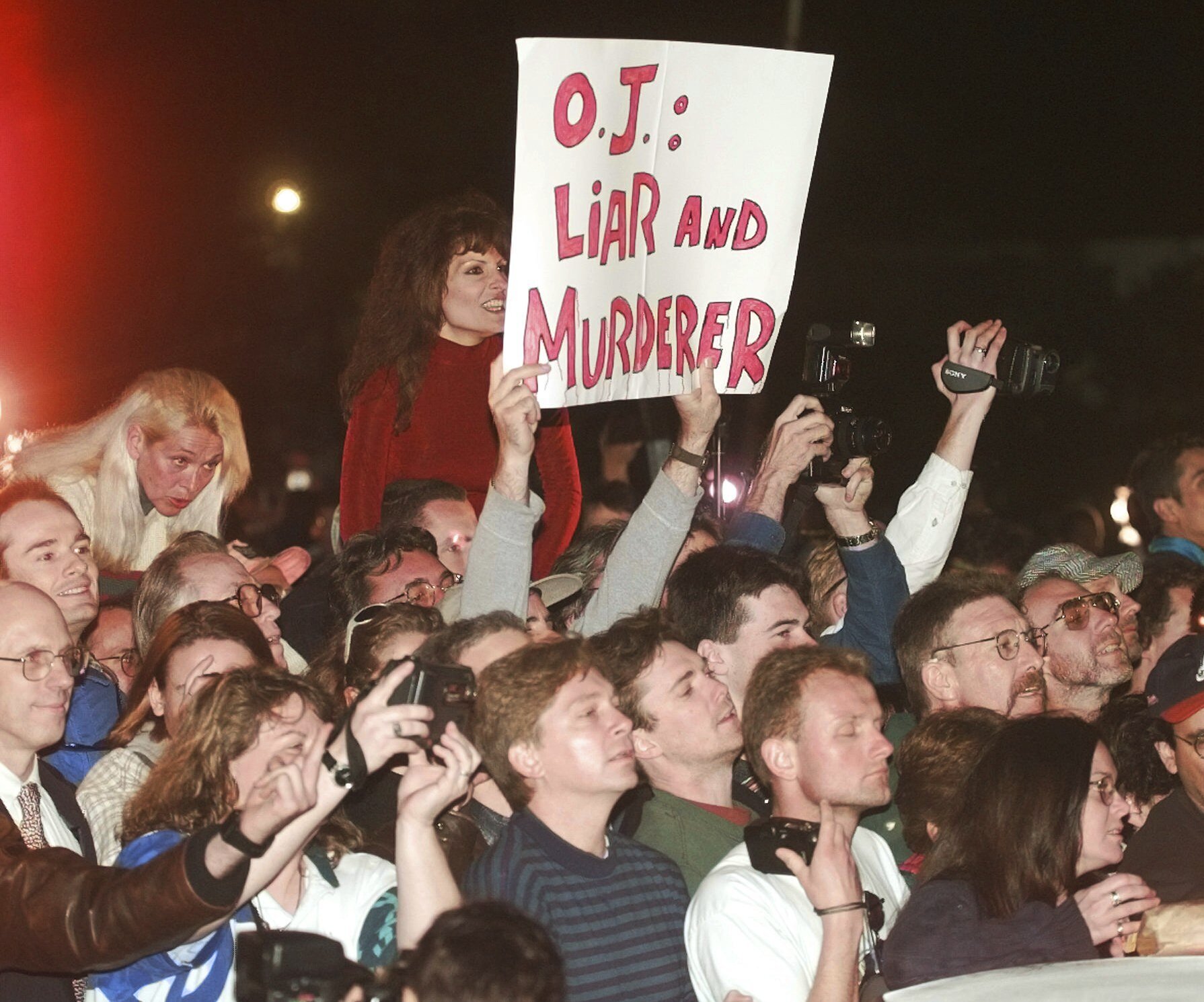 FILE - A crowd reacts to O.J. Simpson leaving Los Angeles County Superior Court, Tuesday, Feb. 4, 1997, in Santa Monica, Calif. after hearing the verdict in the wrongful-death civil trial against O.J. Simpson. Simpson was found liable in the deaths of Nicole Brown Simpson and Ron Goldman. Simpson, the decorated football superstar and Hollywood actor who was acquitted of charges he killed his former wife and her friend but later found liable in a separate civil trial, has died. He was 76. 