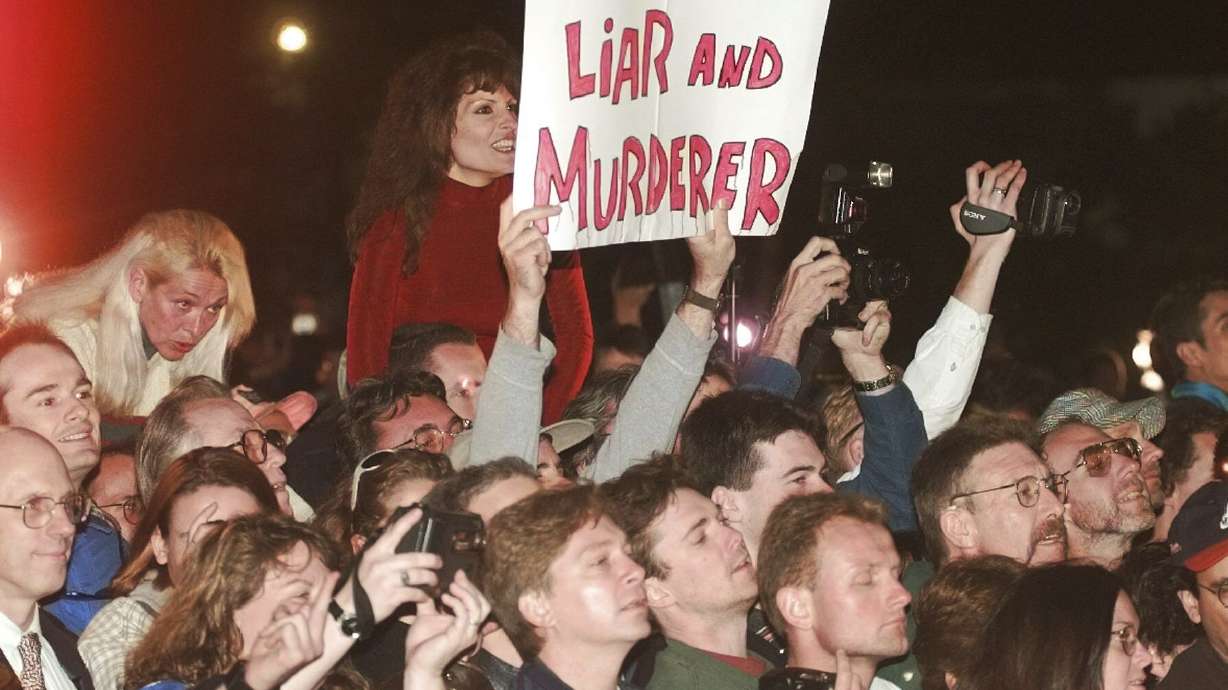 FILE - A crowd reacts to O.J. Simpson leaving Los Angeles County Superior Court, Tuesday, Feb. 4, 1997, in Santa Monica, Calif. after hearing the verdict in the wrongful-death civil trial against O.J. Simpson. Simpson was found liable in the deaths of Nicole Brown Simpson and Ron Goldman. Simpson, the decorated football superstar and Hollywood actor who was acquitted of charges he killed his former wife and her friend but later found liable in a separate civil trial, has died. He was 76.