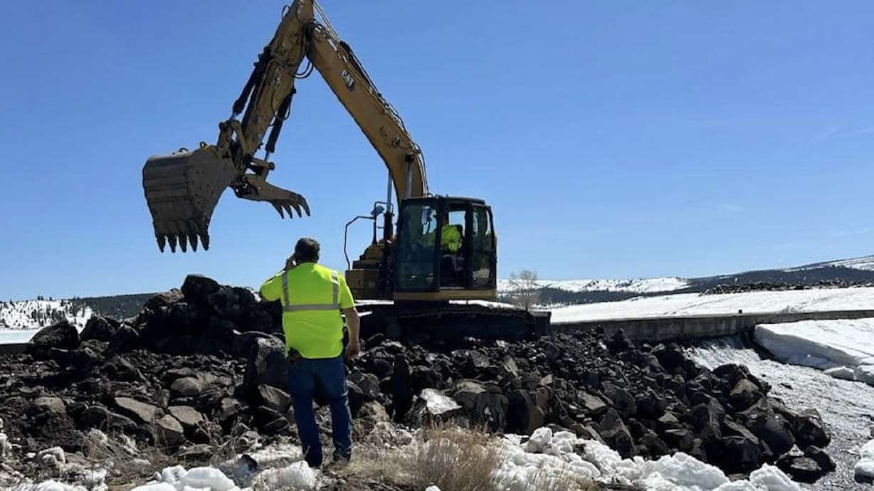 Crews build a buttress by the damaged portion of the Panguitch Lake dam on Wednesday. Utah engineers said they are encouraged by the progress made to repair the dam after damage was discovered on Monday.