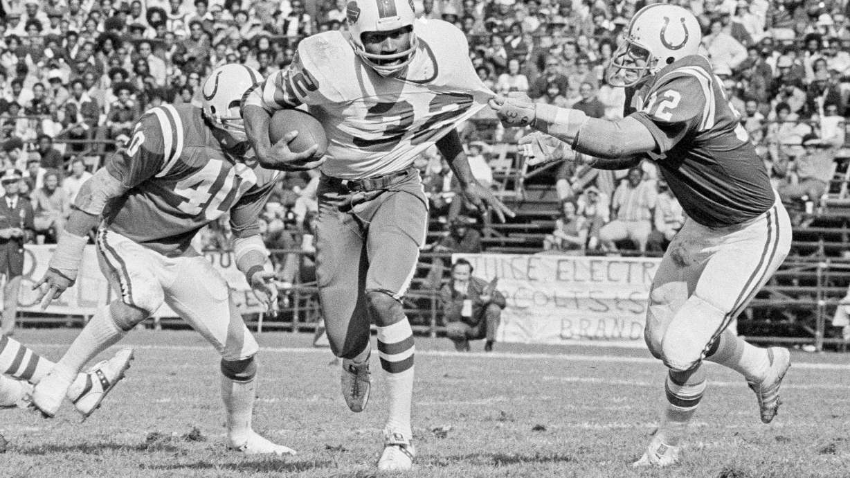 FILE - Buffalo Bulls running back O.J. Simpson (32) has his jersey pulled by Baltimore Colts linebacker Mike Curtis, during the second quarter of an NFL football game in Baltimore, Md., Oct. 12, 1975. Simpson, the decorated football superstar and Hollywood actor who was acquitted of charges he killed his former wife and her friend but later found liable in a separate civil trial, died Wednesday, April 11, 2024, of prostate cancer. He was 76.