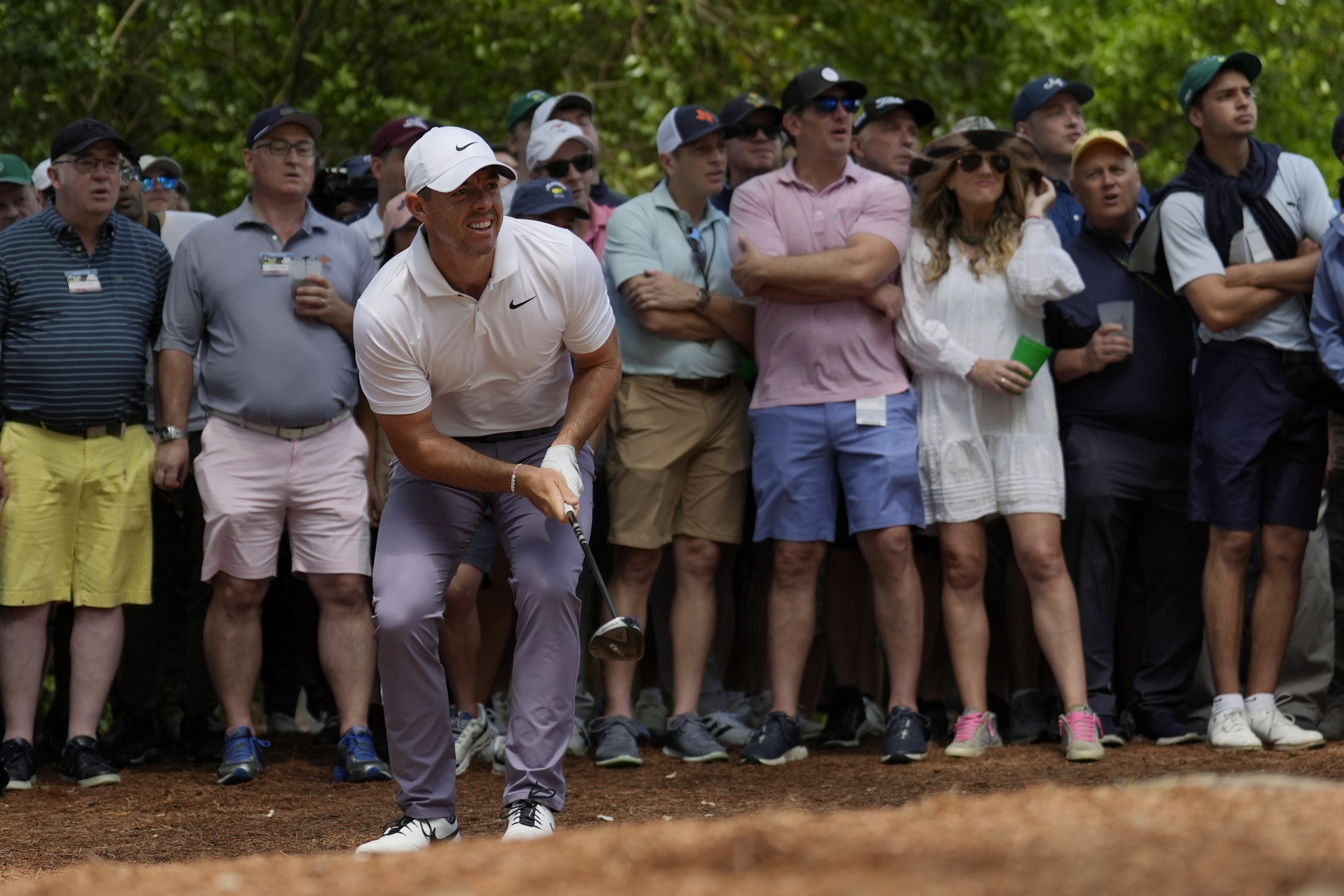 Rory McIlroy, of Northern Ireland, watches his shot from the pine straw on the second hole during the first round at the Masters golf tournament at Augusta National Golf Club Thursday, April 11, 2024, in Augusta, Ga. 