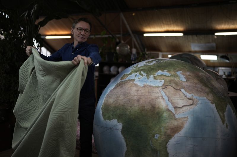 Peter Bellerby, the founder of Bellerby & Co. Globemakers, covers a globe at his studio in London, Feb. 27. In 2008, he founded Bellerby & Co. Globemakers in London. His team of dozens of artists and cartographers has made thousands of bespoke globes up to 50 inches in diameter.