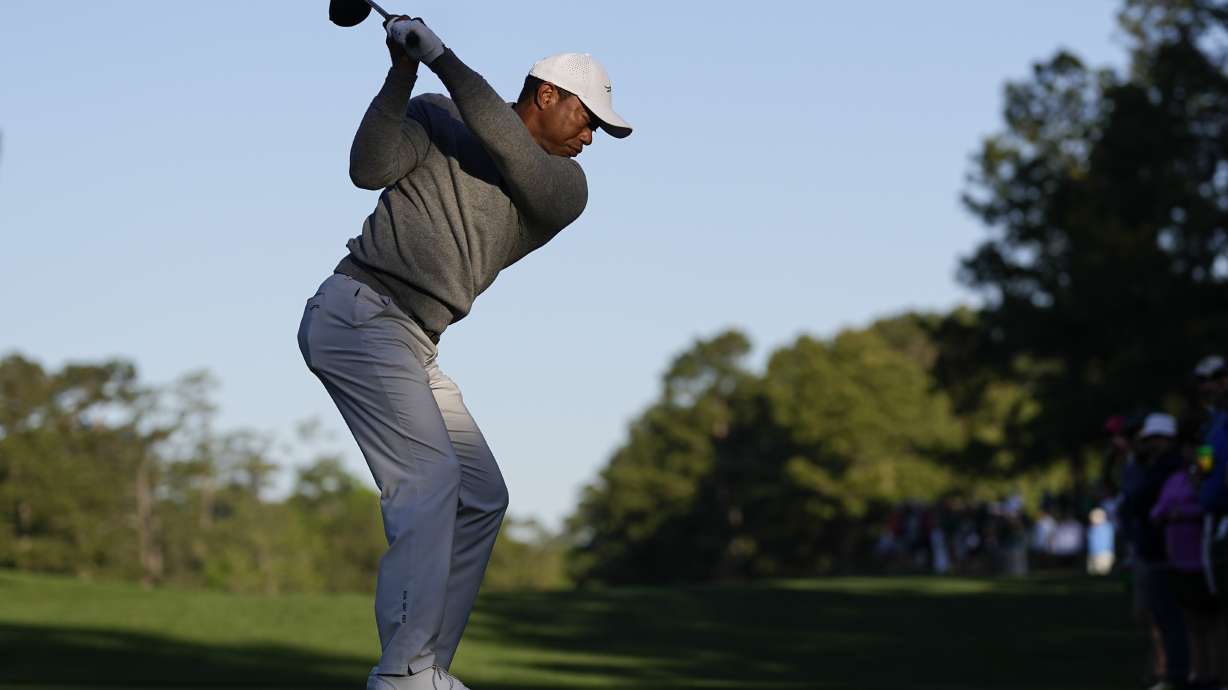 Tiger Woods hits his tee shot on the 15th hole during the weather delayed first round at the Masters golf tournament at Augusta National Golf Club Friday, April 12, 2024, in Augusta, Ga.