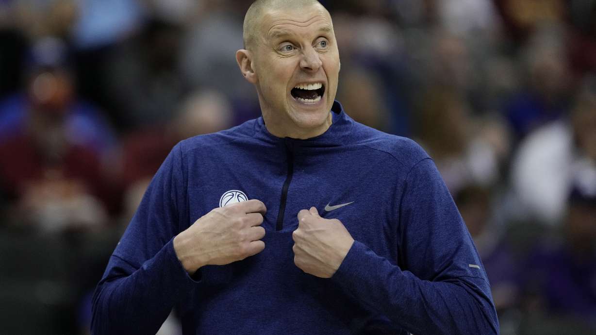 BYU head coach Mark Pope talks to his players during the first half of an NCAA college basketball game against UCF Wednesday, March 13, 2024, in Kansas City, Mo. Kentucky has hired BYU’s Mark Pope as men’s basketball coach, bringing home a member of the Wildcats’ 1996 national championship team to succeed John Calipari. The school announced Pope’s hiring in a release Friday morning, April 12, but did not mention any contract details. The 51-year-old Pope will be introduced at a later date, the release said.