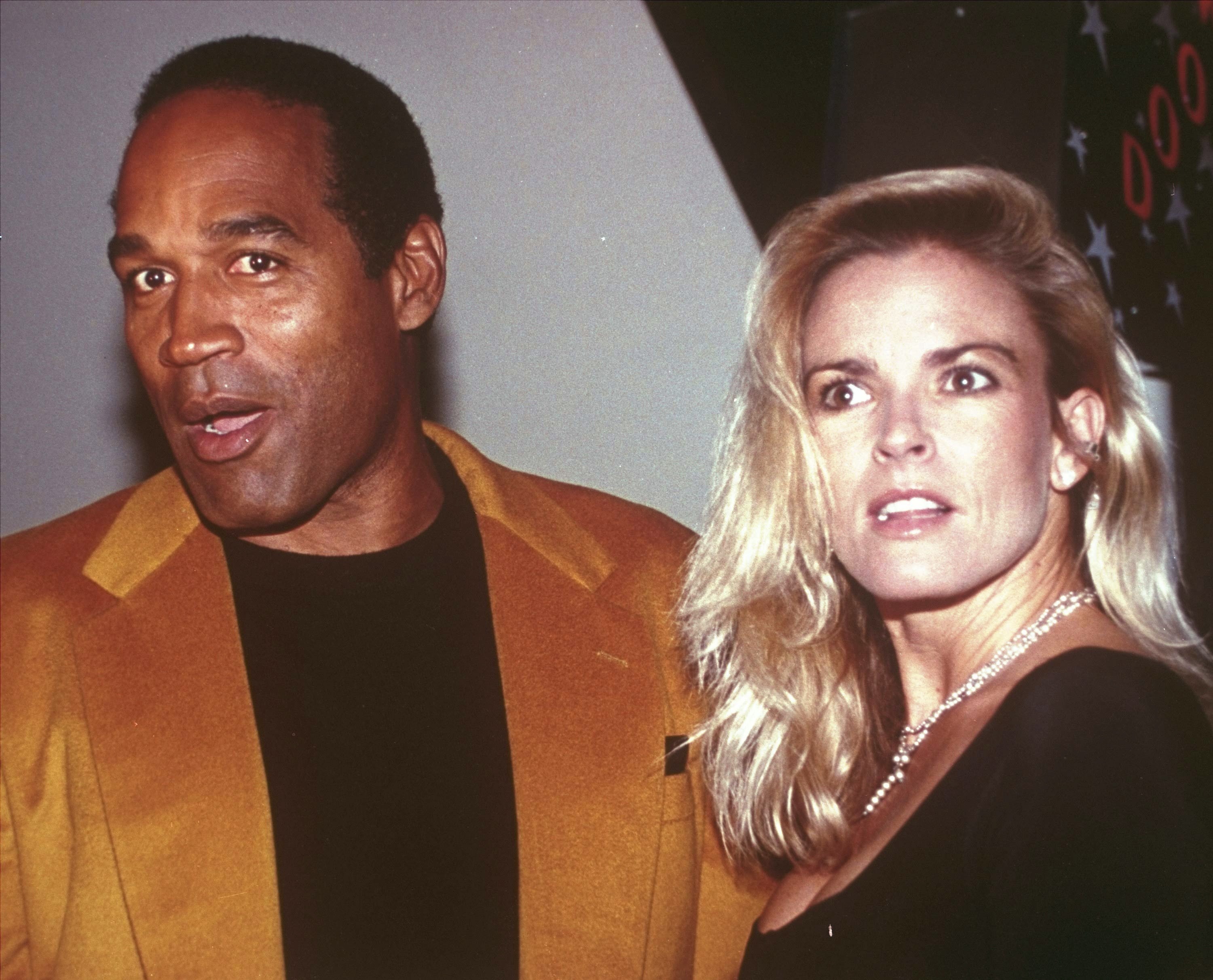 FILE - O.J. Simpson and his wife, Nicole Brown Simpson, arrive for the opening of the Harley-Davidson Cafe in New York on Oct. 19, 1993. Simpson, the decorated football superstar and Hollywood actor who was acquitted of charges he killed Nicole Brown Simpson and her friend but later found liable in a separate civil trial, has died. He was 76. 