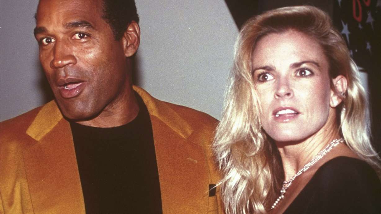 FILE - O.J. Simpson and his wife, Nicole Brown Simpson, arrive for the opening of the Harley-Davidson Cafe in New York on Oct. 19, 1993. Simpson, the decorated football superstar and Hollywood actor who was acquitted of charges he killed Nicole Brown Simpson and her friend but later found liable in a separate civil trial, has died. He was 76.