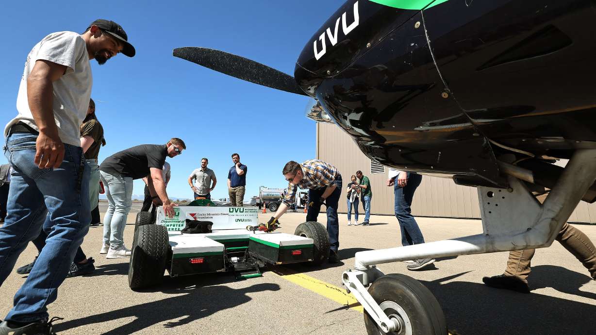 Utah Valley University students tests their prototype electric-powered, autonomous vehicle during a demo at Provo Airport in Provo on Friday. The tug will reduce emissions while performing the task of moving airplanes at busy airports.