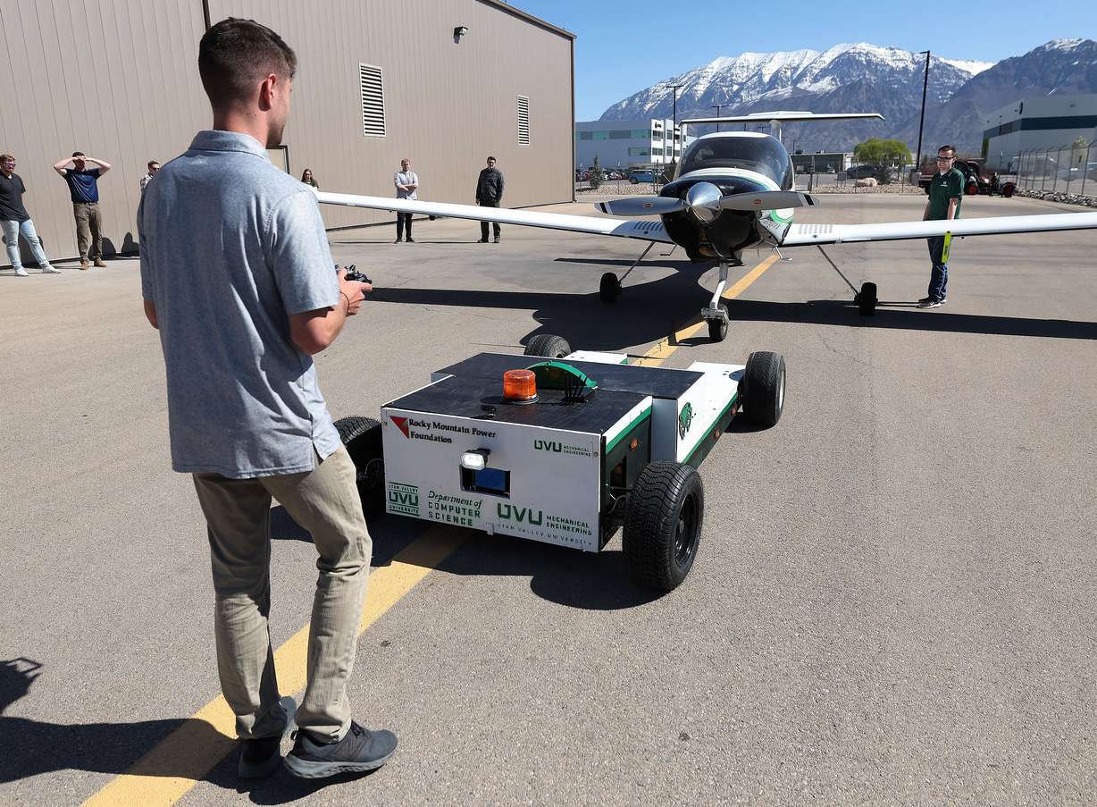 Utah Valley University student Cache Fulton remote drives the school's prototype electric-powered, autonomous vehicle during a demo at Provo Airport in Provo on Friday. The tug will reduce emissions while performing the task of moving airplanes at busy airports.