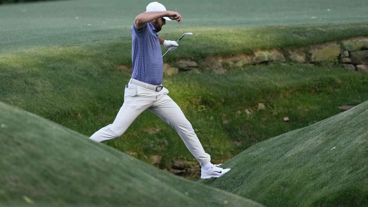 Scottie Scheffler keeps over Rae's Creek on the 13th hole during second round at the Masters golf tournament at Augusta National Golf Club Friday, April 12, 2024, in Augusta, Ga.