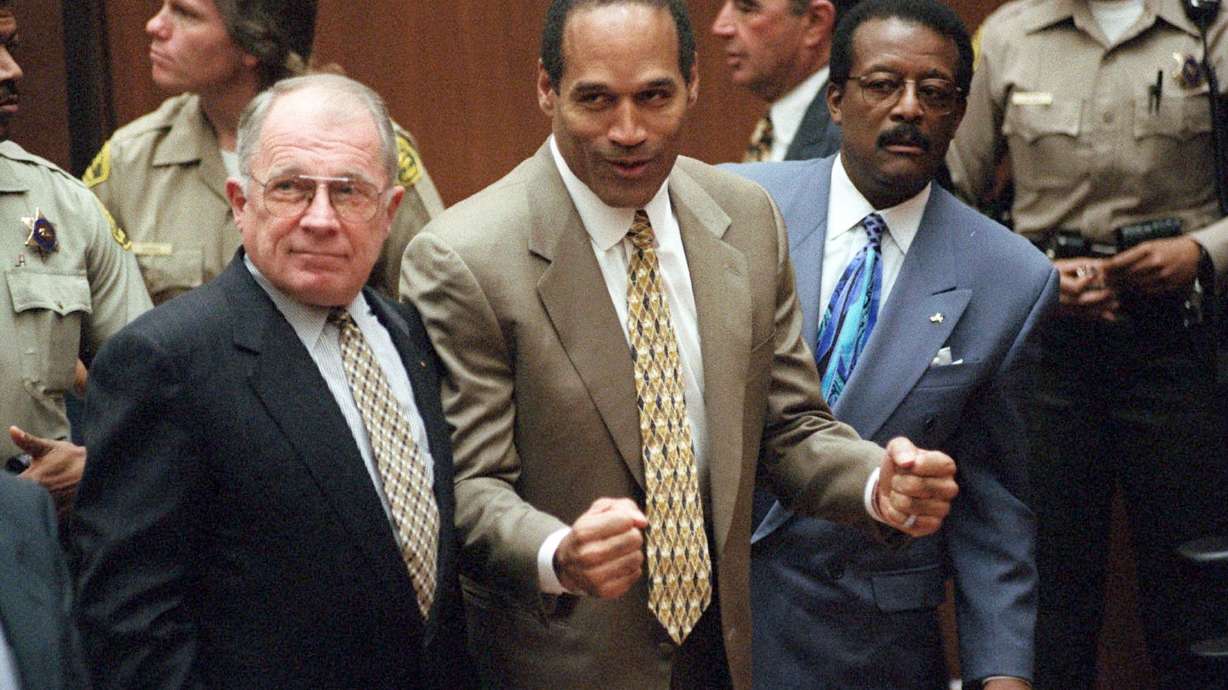 On Oct. 3, 1995, O.J. Simpson reacts as he is found not guilty in the death of his ex-wife Nicole Brown Simpson and her friend Ron Goldman in Los Angeles. Defense attorneys F. Lee Bailey, left, and Johnnie L. Cochran Jr. stand with him.